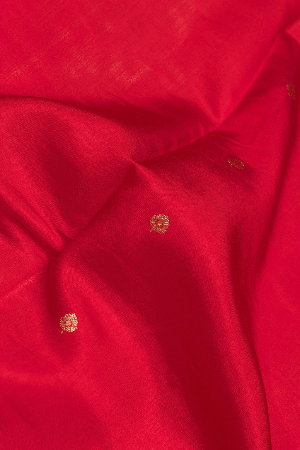 Close up of Red Dual Tone Banarasi Silk Saree with Zari Butta on the body and Fancy Border.  displaying folds