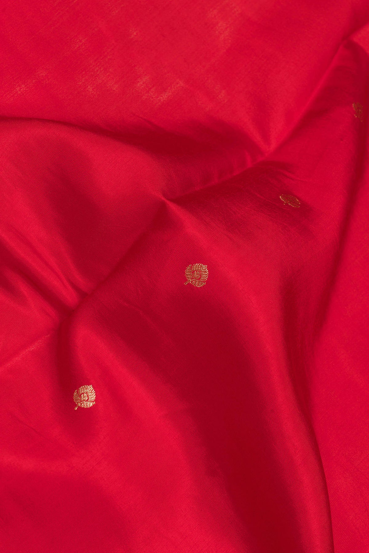 Close up of Red Dual Tone Banarasi Silk Saree with Zari Butta on the body and Fancy Border.  displaying folds