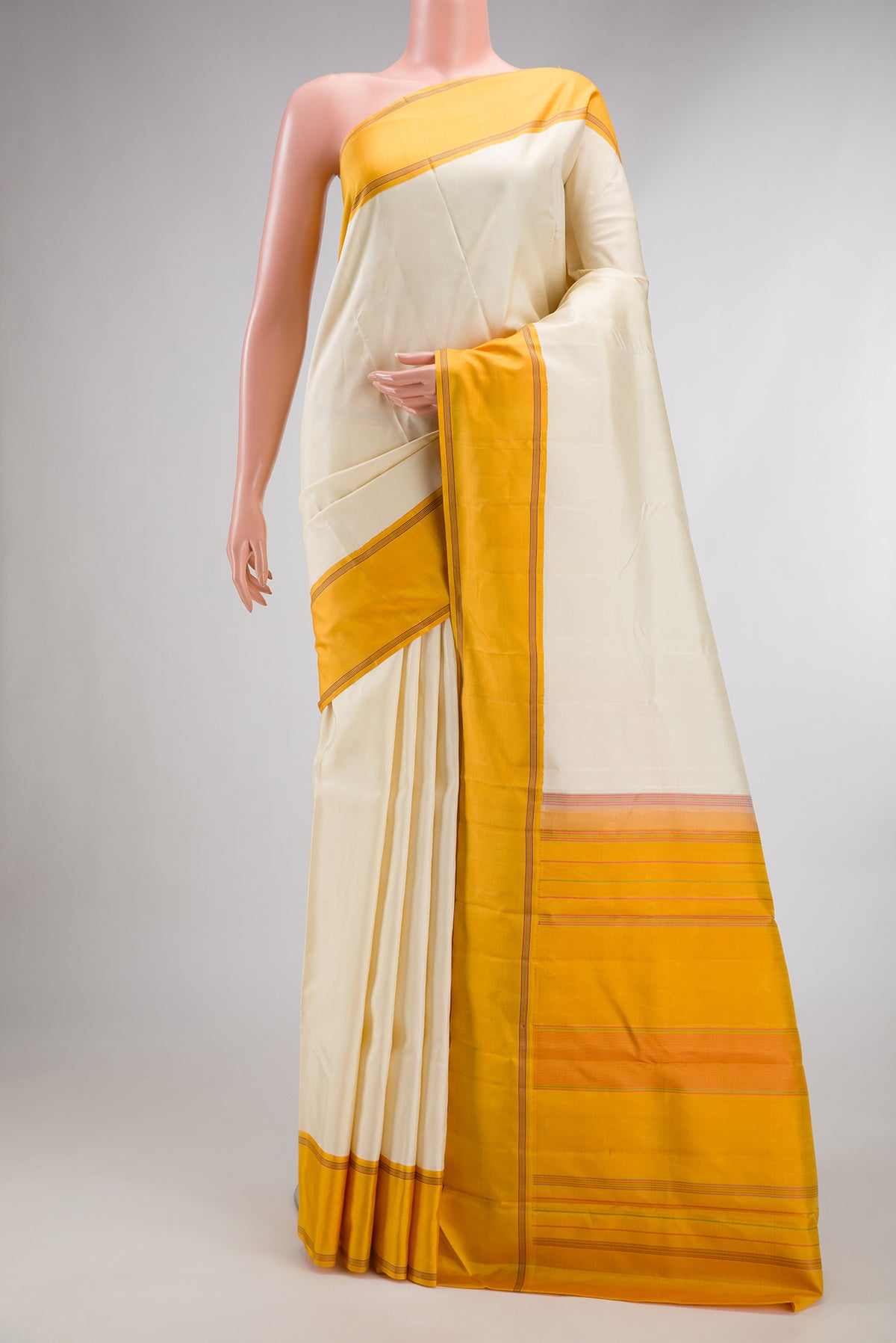 Pure Silk Cream Kanjivaram Saree with Plain Body and Plain Border.  displayed on a mannequin