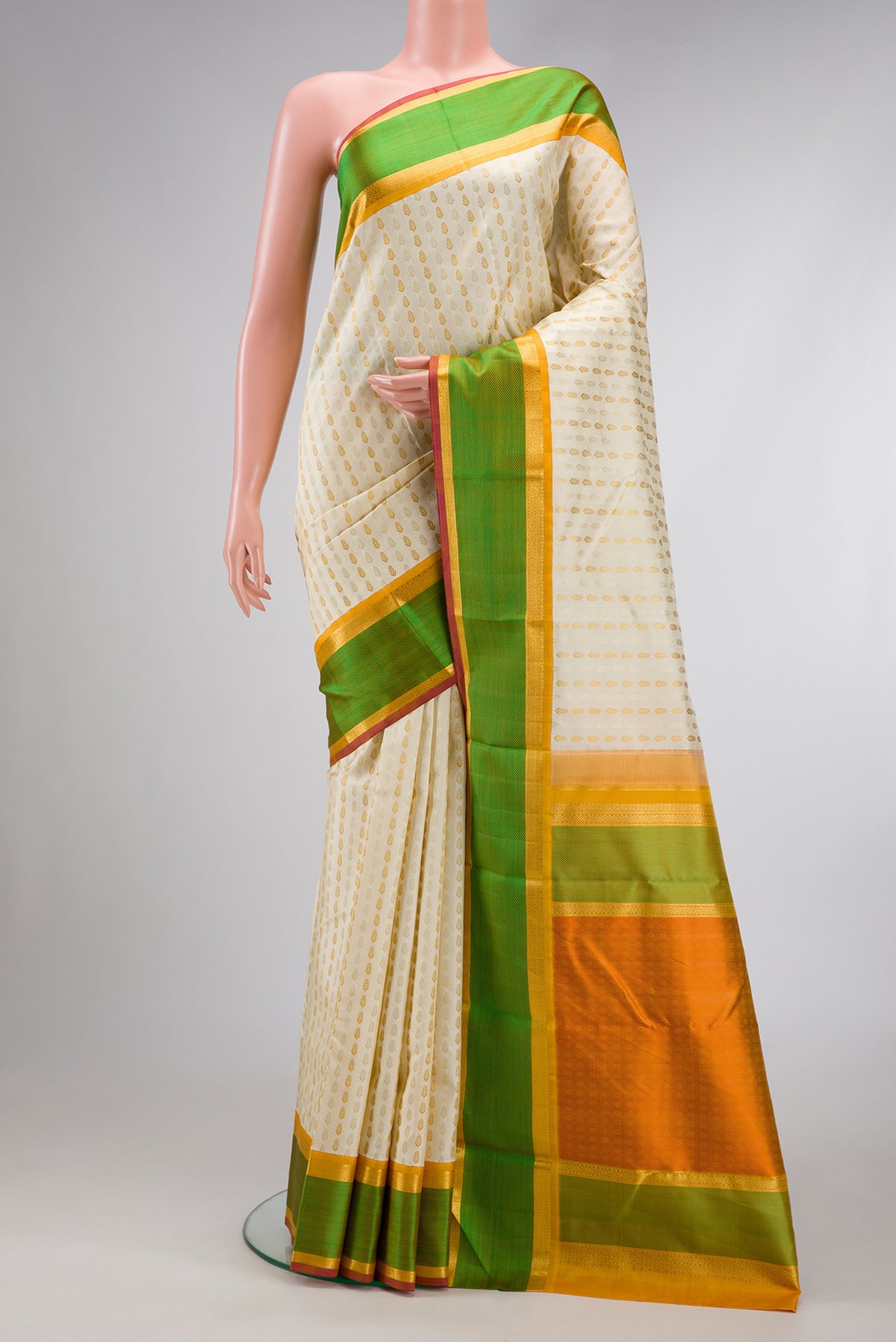 Pure Silk Pure Zari Off White Dual Tone Kanchipuram Saree with Zari Butta on the body and Zari And Thread Border.  displayed on a mannequin