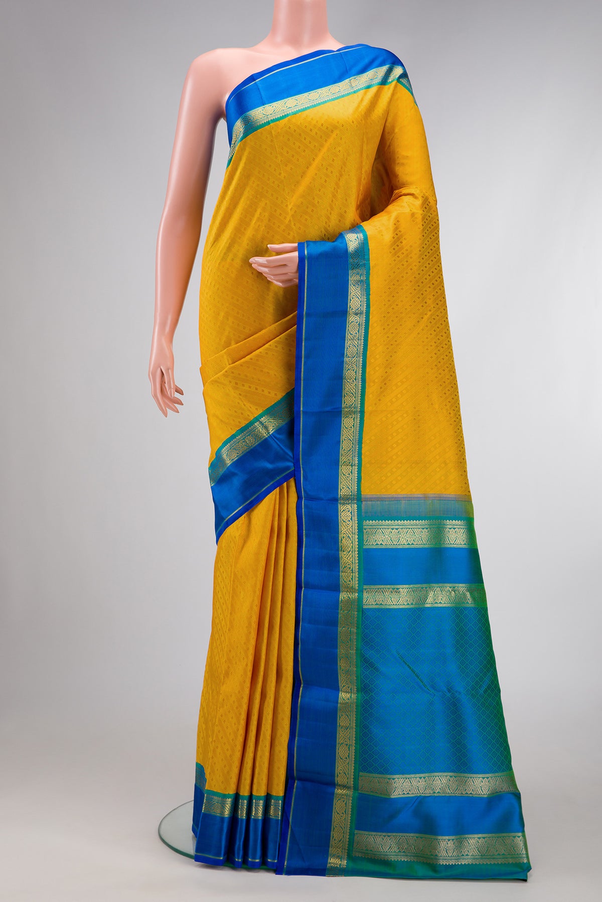 Pure Silk Pure Zari Mustard Dual Tone Kanchipuram Saree with Jacquard design on the body and Zari Border.  displayed on a mannequin