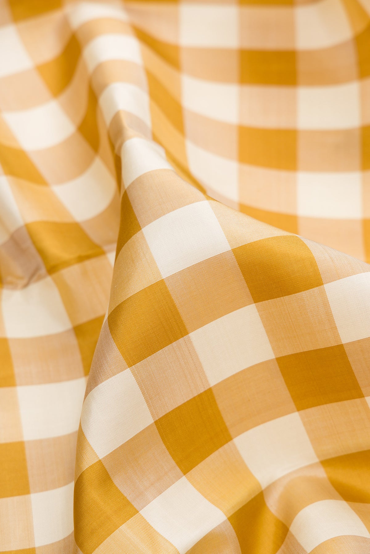 Close up of Pure Silk Pure Zari Multi Color Kanjivaram Saree with Checked design on the body and Zari Border.  displaying folds