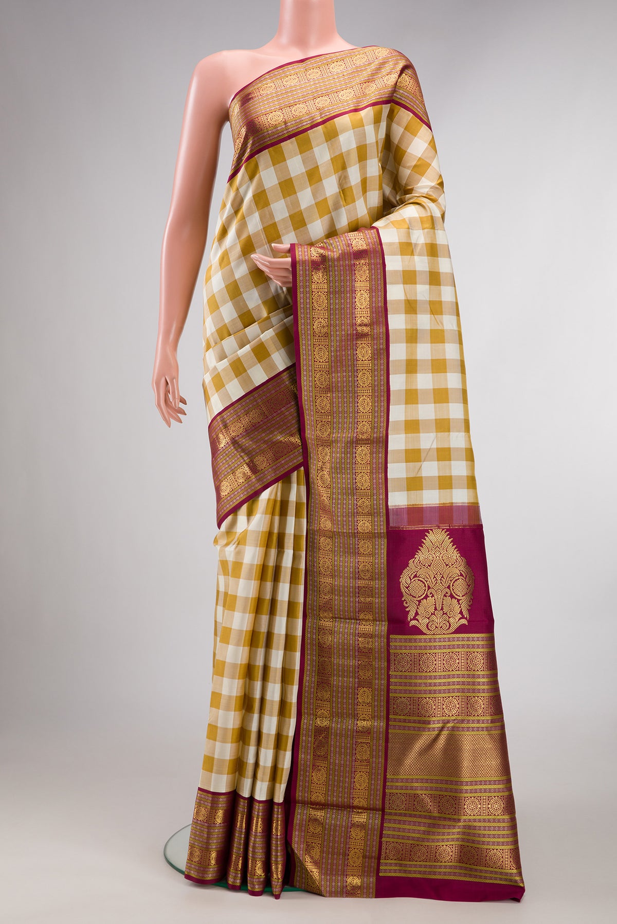 Pure Silk Pure Zari Multi Color Kanjivaram Saree with Checked design on the body and Zari Border.  displayed on a mannequin