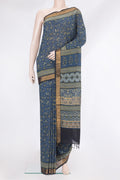 Grey Linen Saree with Printed design on the body and Zari Border.  displayed on a mannequin