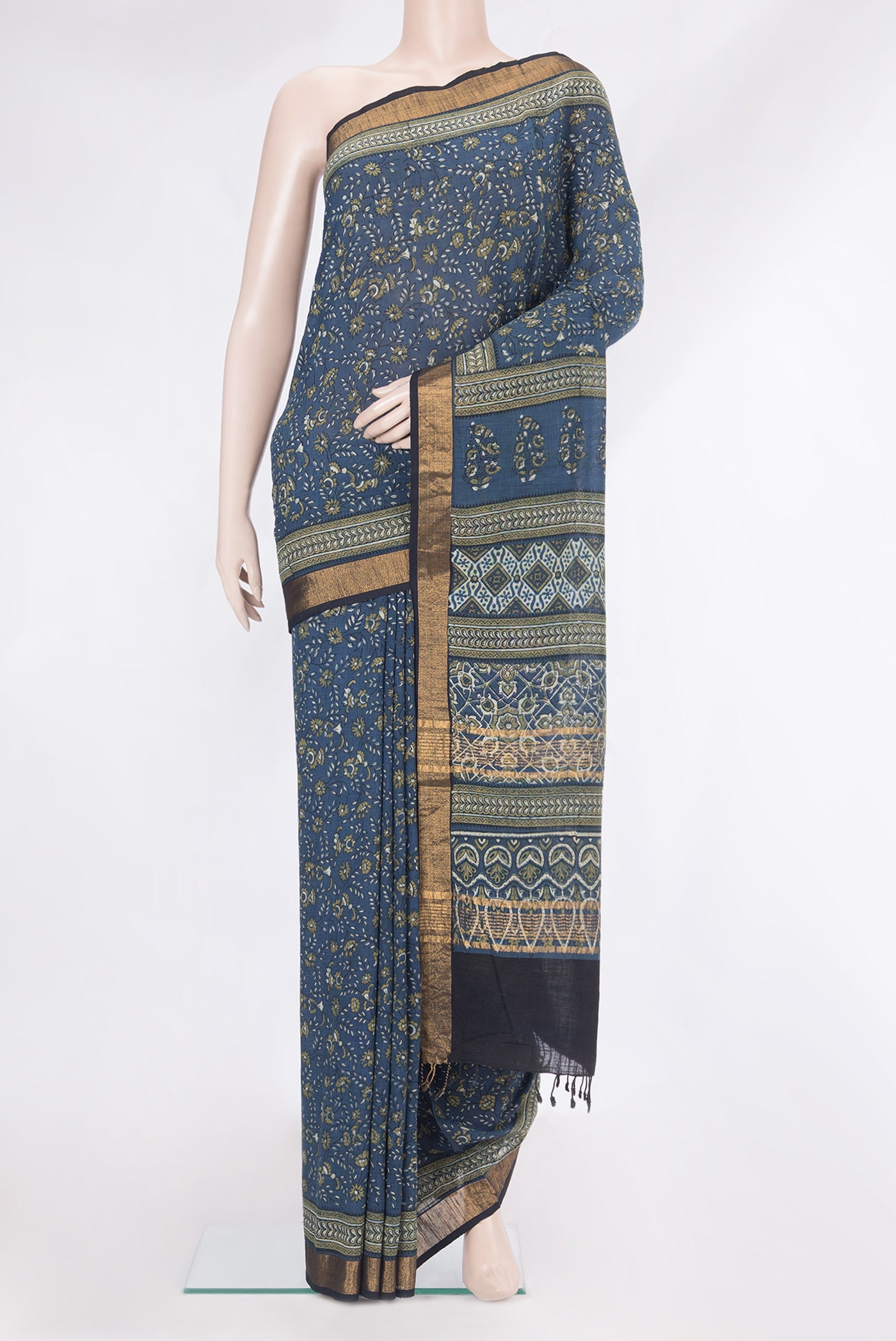 Grey Linen Saree with Printed design on the body and Zari Border.  displayed on a mannequin