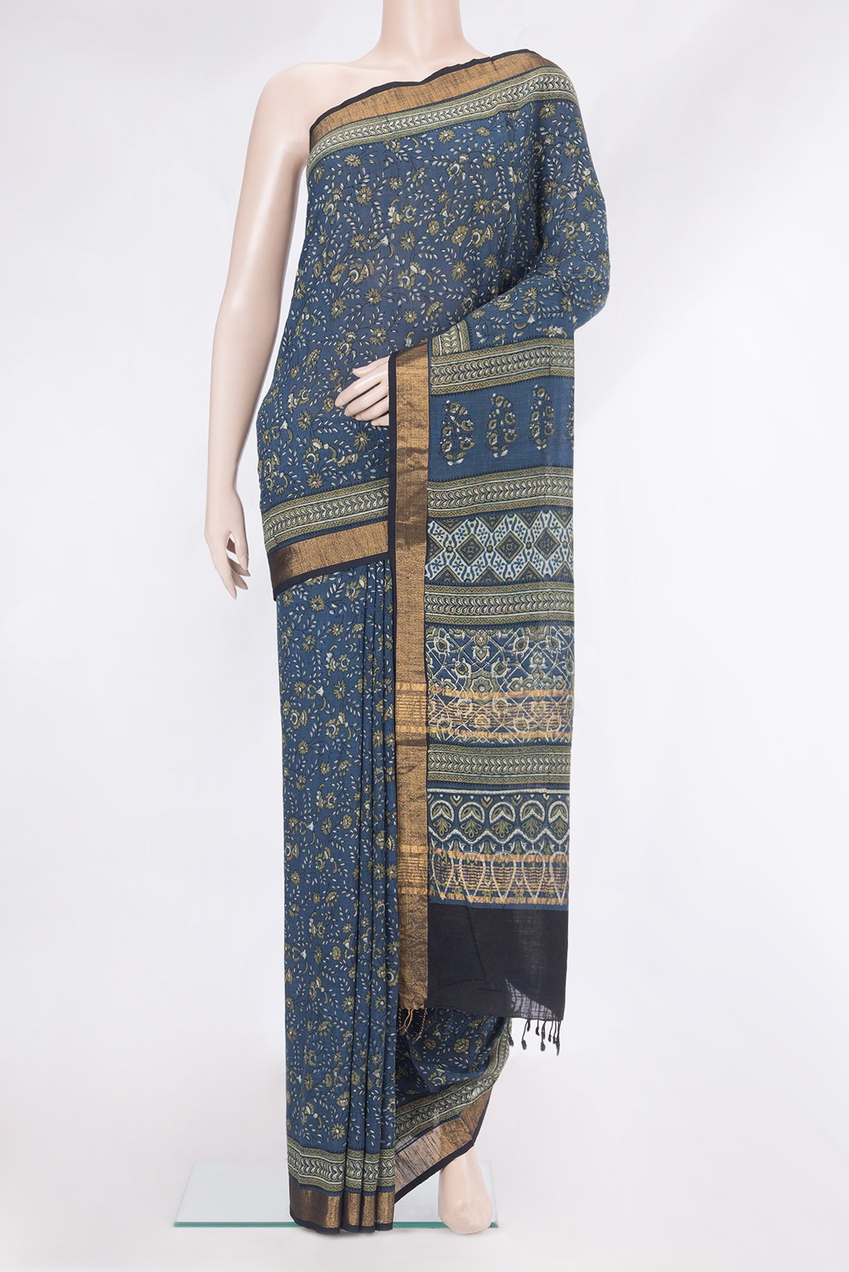 Grey Linen Saree with Printed design on the body and Zari Border.  displayed on a mannequin