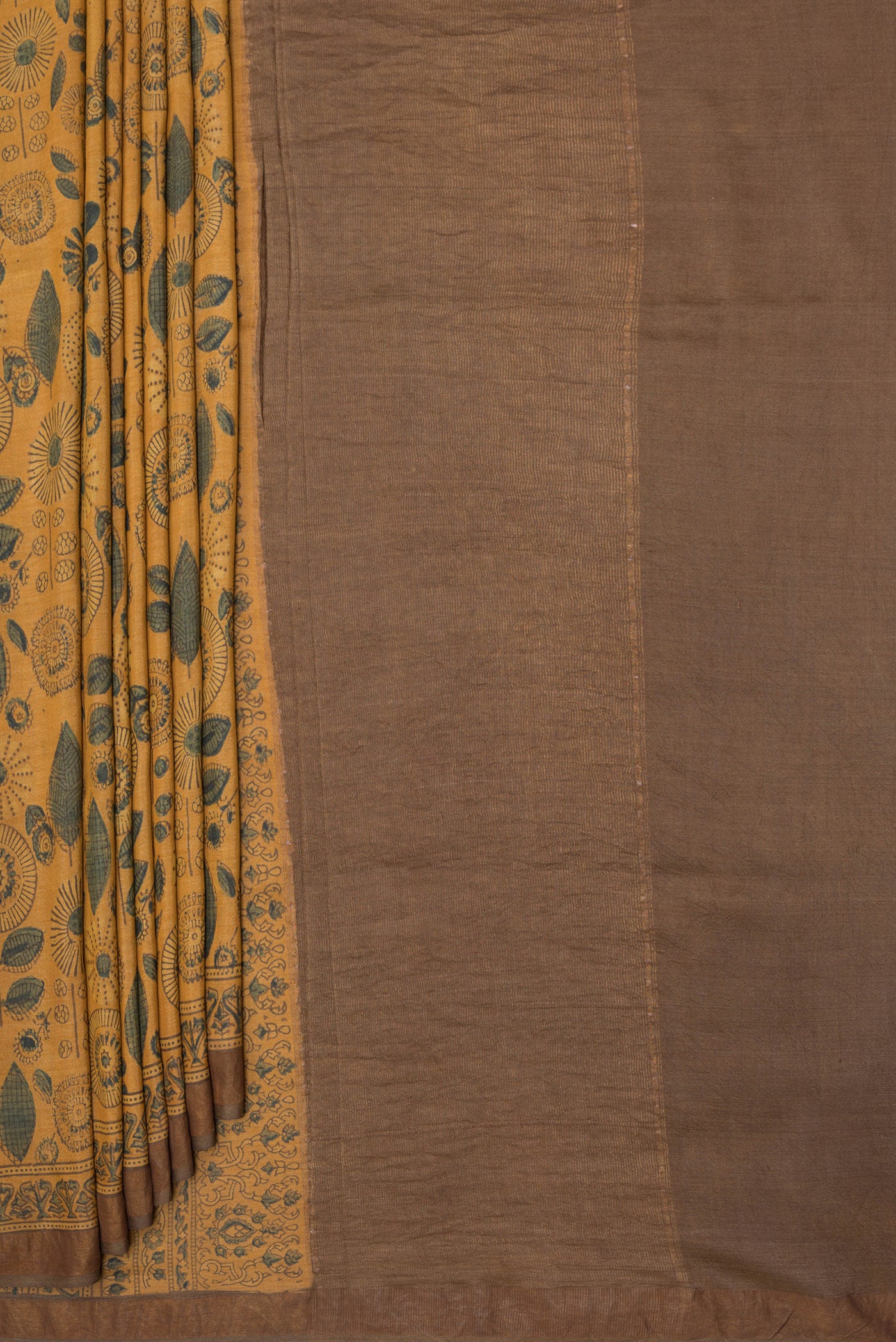 Pleats and pallu of Mustard Tussar Silk Saree with Printed design on the body and Zari Border. 