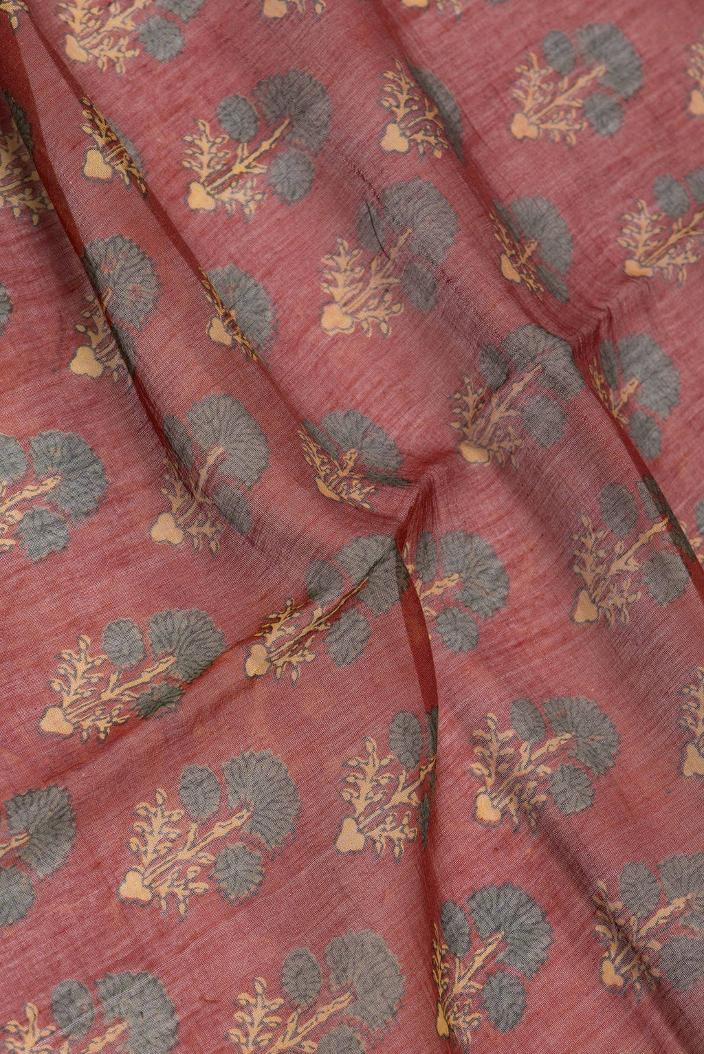 Close up of Maroon Chanderi Silk Cotton Saree with Ajrakh Print on the body and Zari Border.  displaying folds