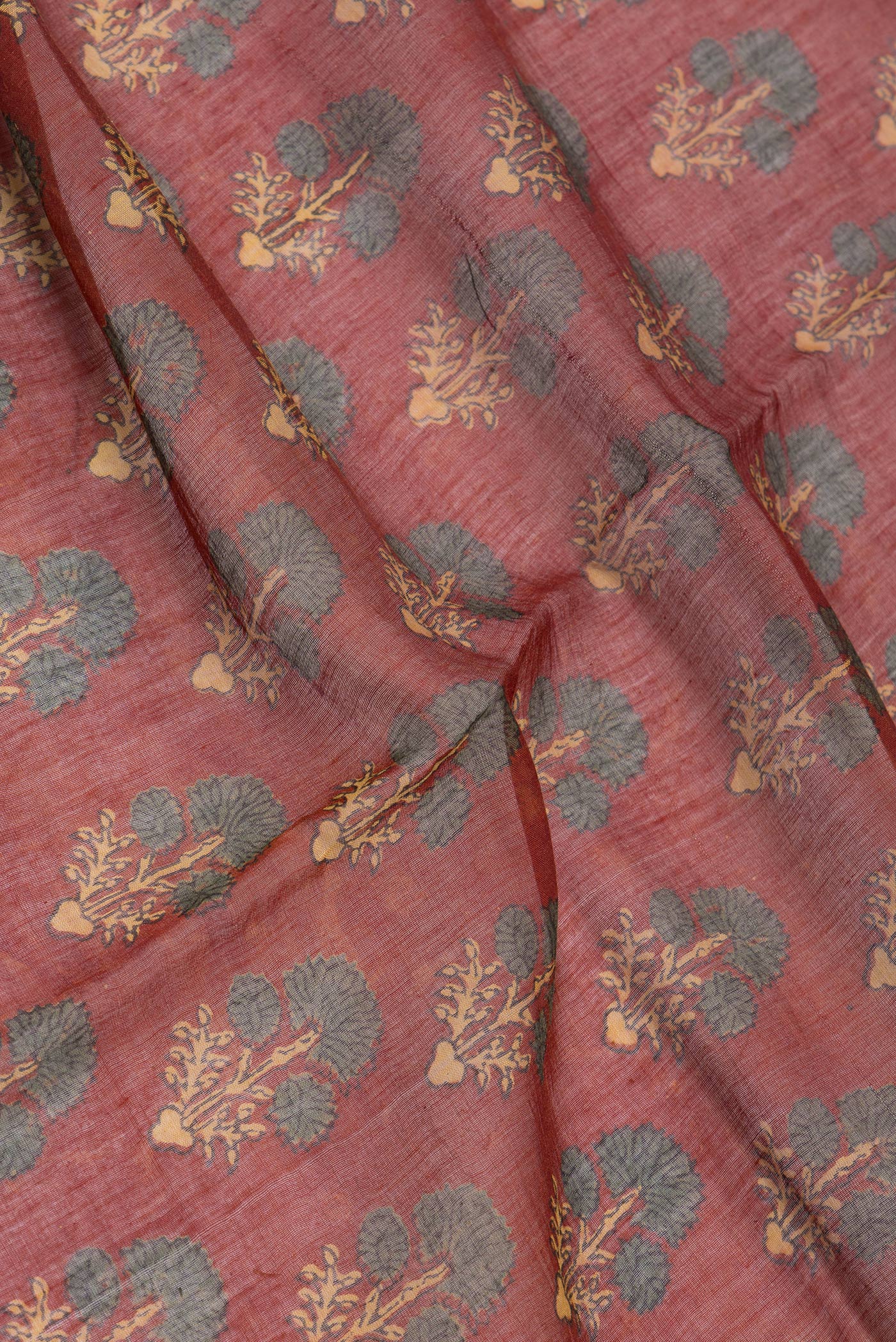 Close up of Maroon Chanderi Silk Cotton Saree with Ajrakh Print on the body and Zari Border.  displaying folds