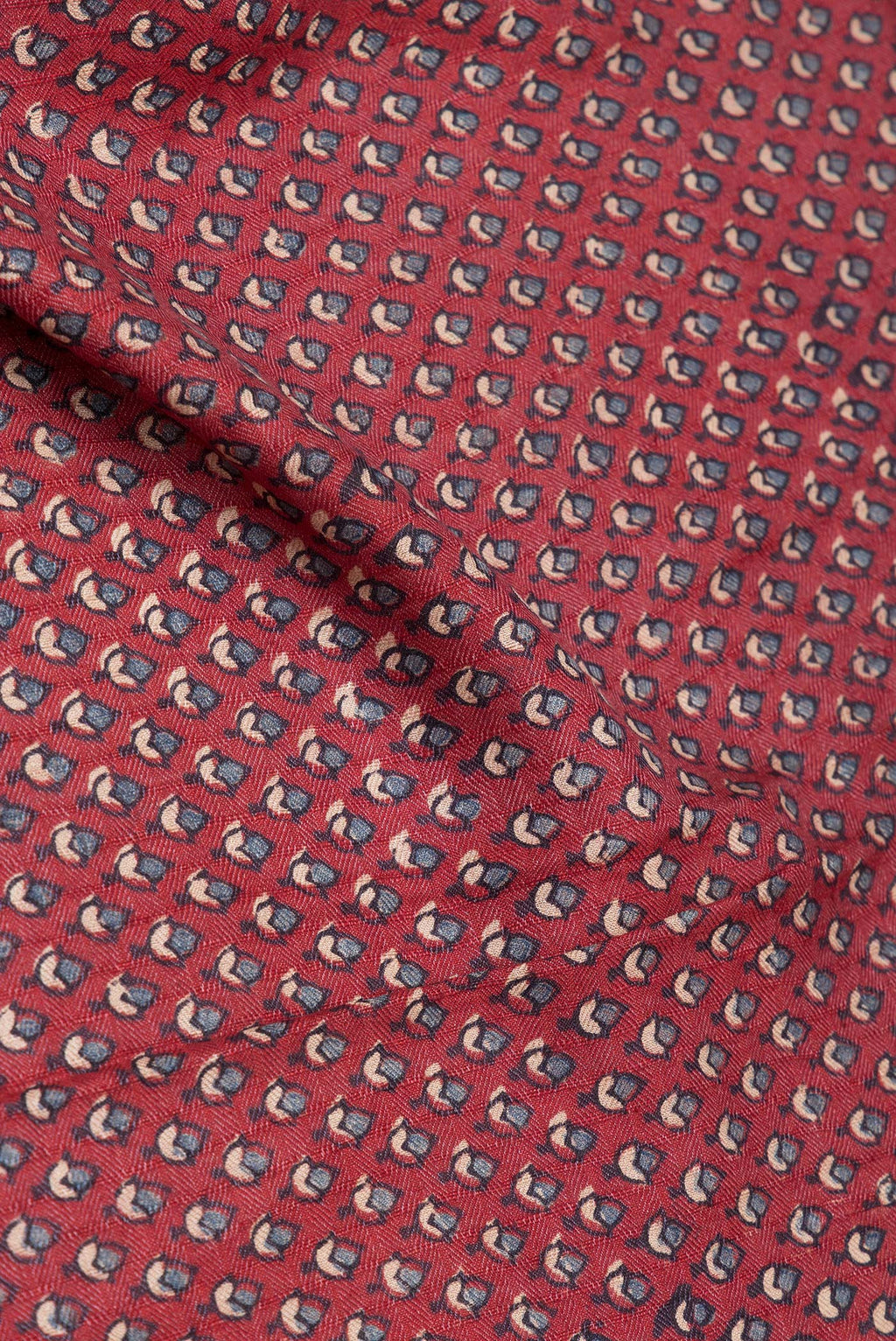 Close up of Maroon Jute Silk Saree with Ajrakh Print on the body and Zari Border.  displaying folds