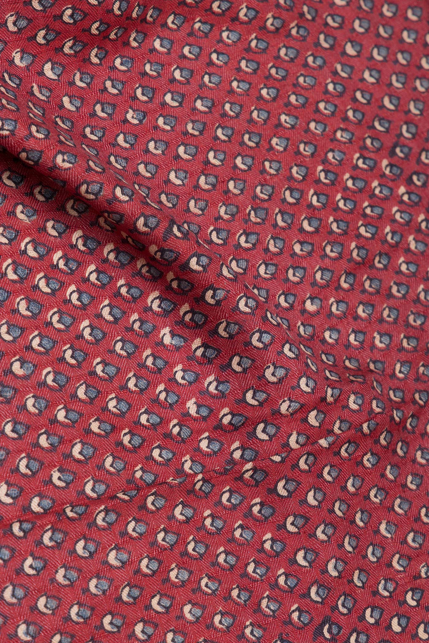 Close up of Maroon Jute Silk Saree with Ajrakh Print on the body and Zari Border.  displaying folds