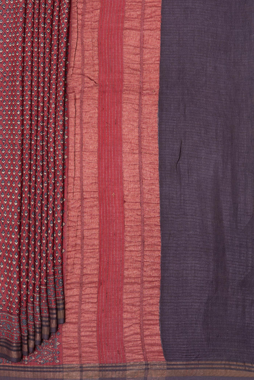 Pleats and pallu of Maroon Jute Silk Saree with Ajrakh Print on the body and Zari Border. 