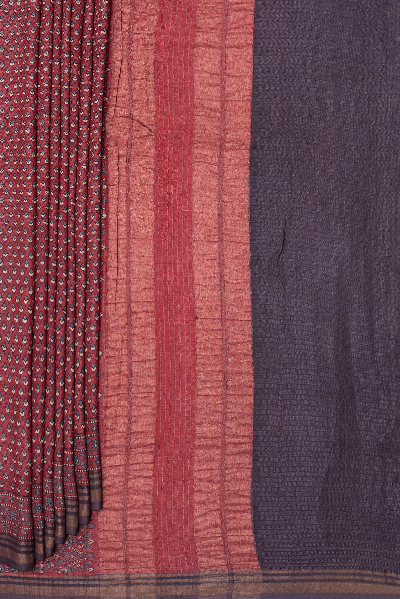 Pleats and pallu of Maroon Jute Silk Saree with Ajrakh Print on the body and Zari Border. 