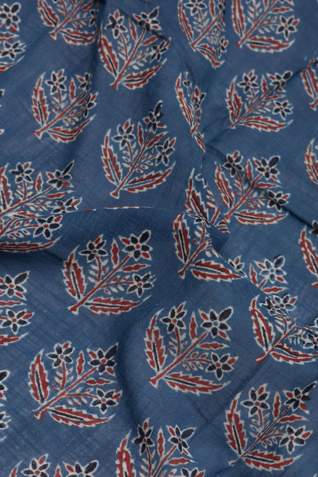 Close up of Indigo Linen Saree with Printed design on the body and Zari Border.  displaying folds