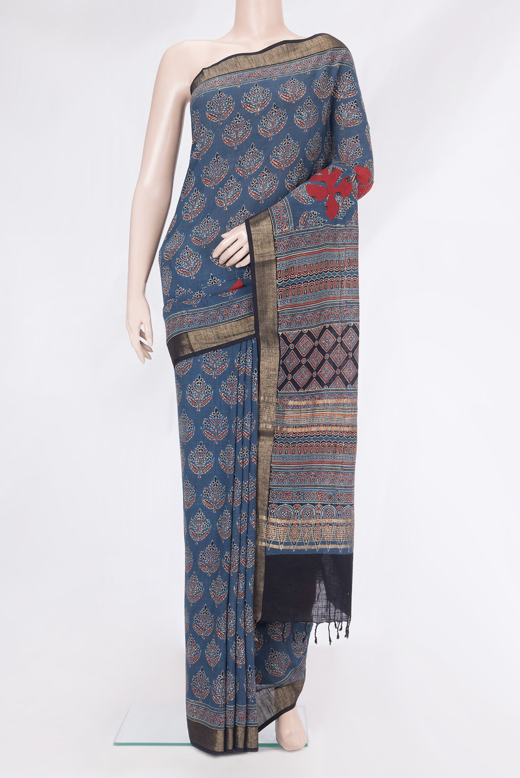 Indigo Linen Saree with Printed design on the body and Zari Border.  displayed on a mannequin