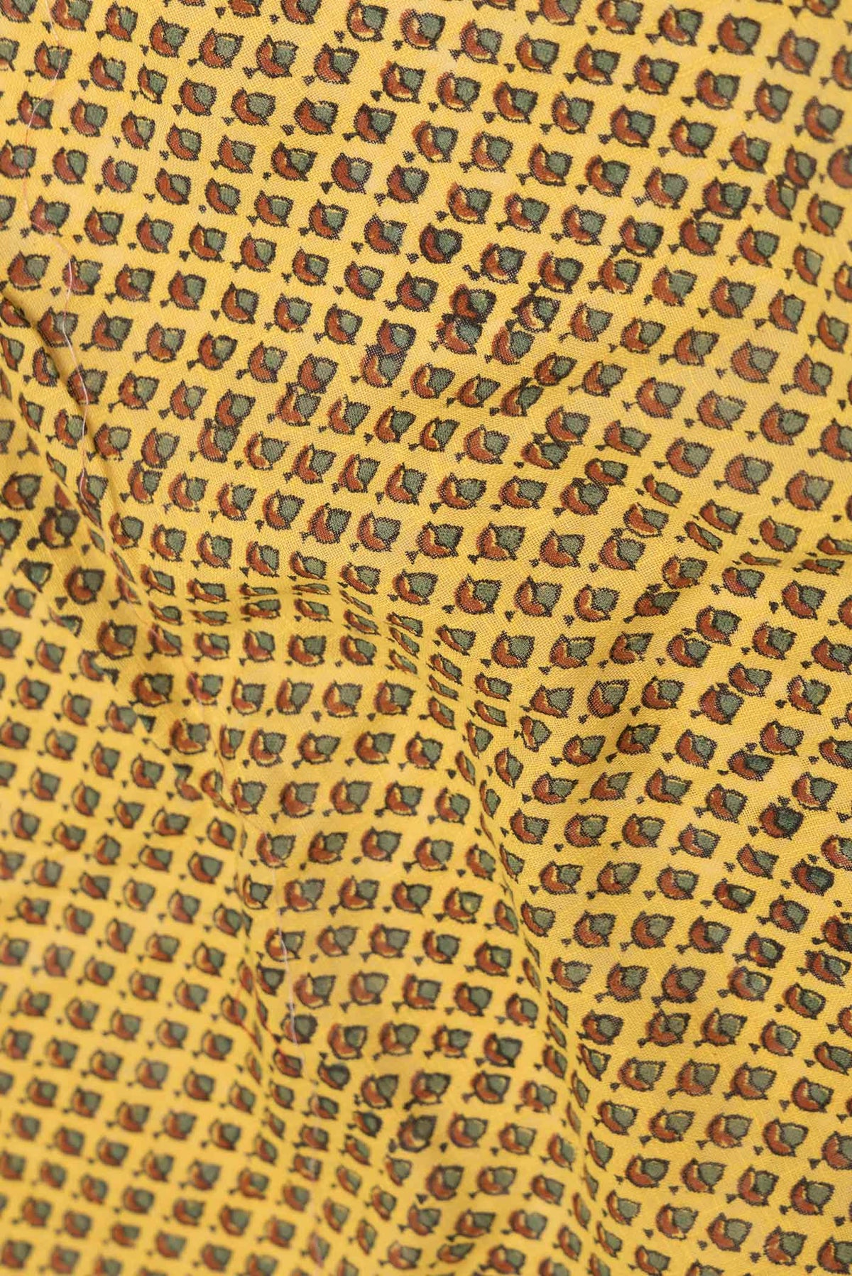 Close up of Yellow Dual Tone Linen Cotton Saree with Printed design on the body and Zari Border displaying folds