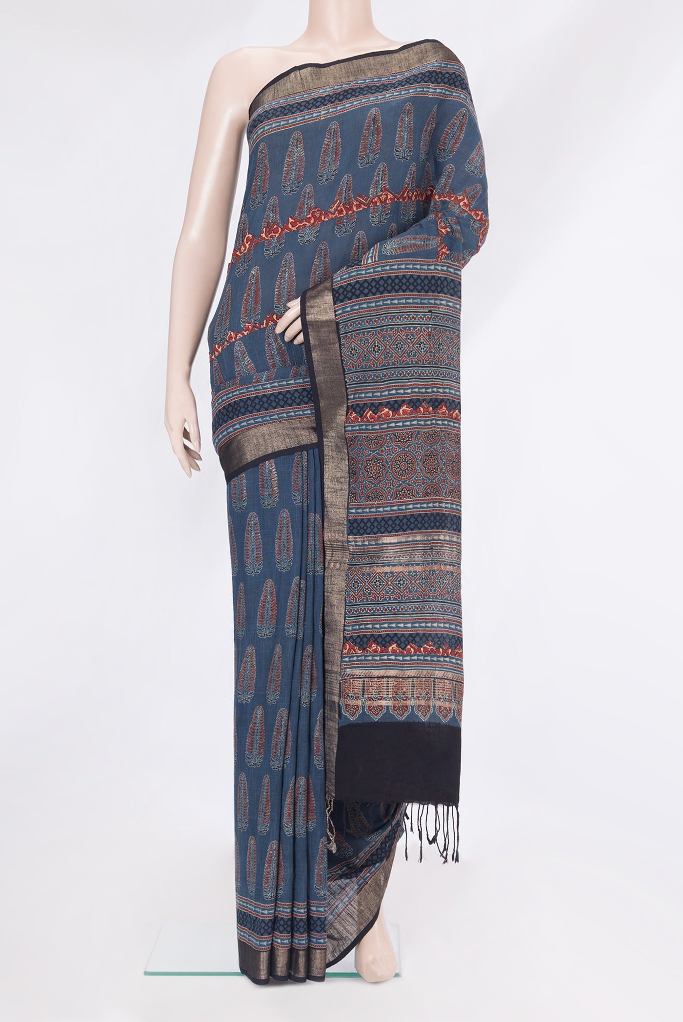 Indigo Linen Saree with Ajrakh Print on the body and Zari Border.  displayed on a mannequin