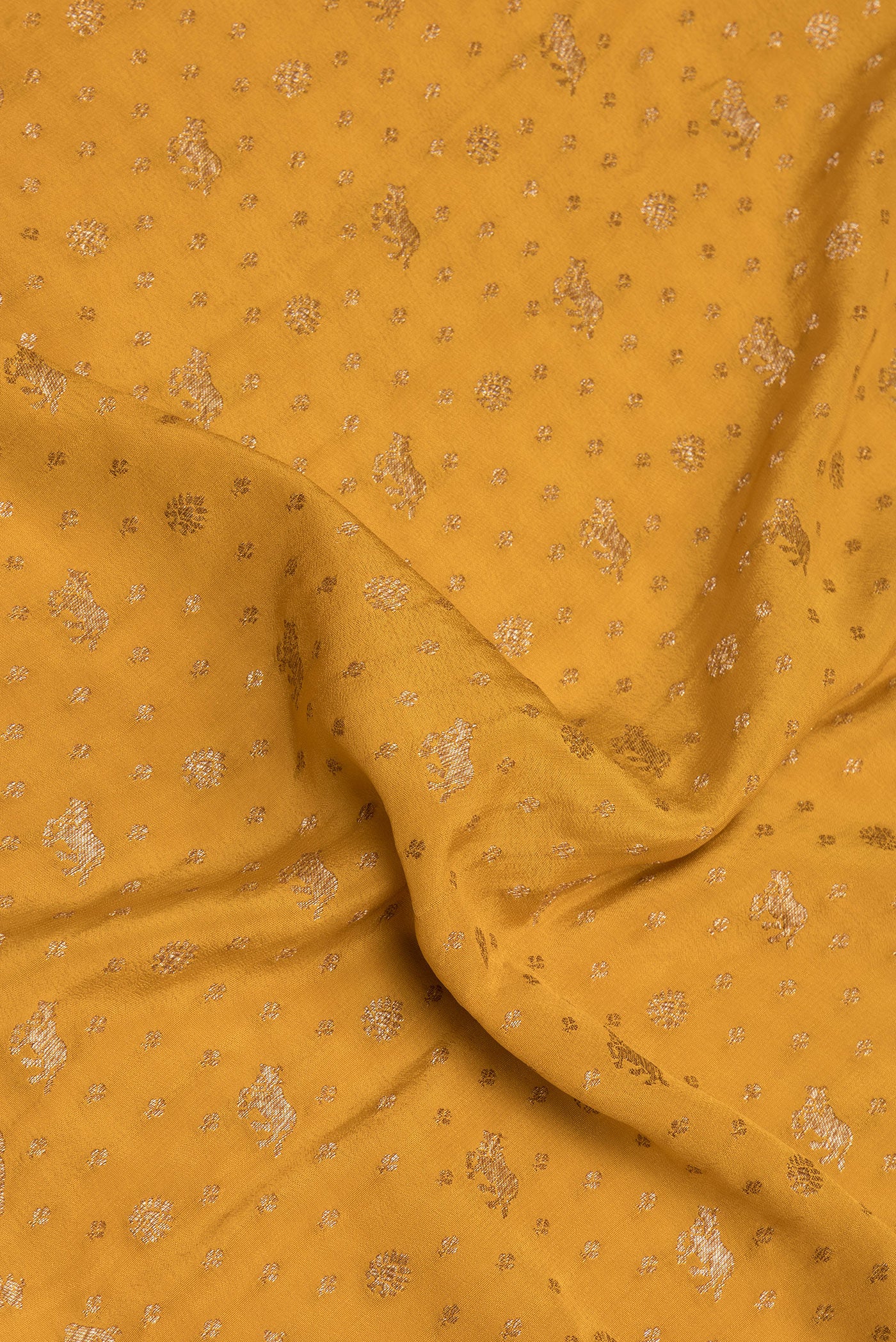 Close up of Mustard Banarasi Georgette Saree with Zari Butta on the body and Zari Border.  displaying folds