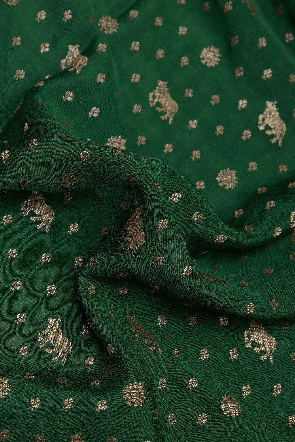 Close up of Bottle Green Banarasi Georgette Saree with Zari Brocade on the body and Zari Border.  displaying folds