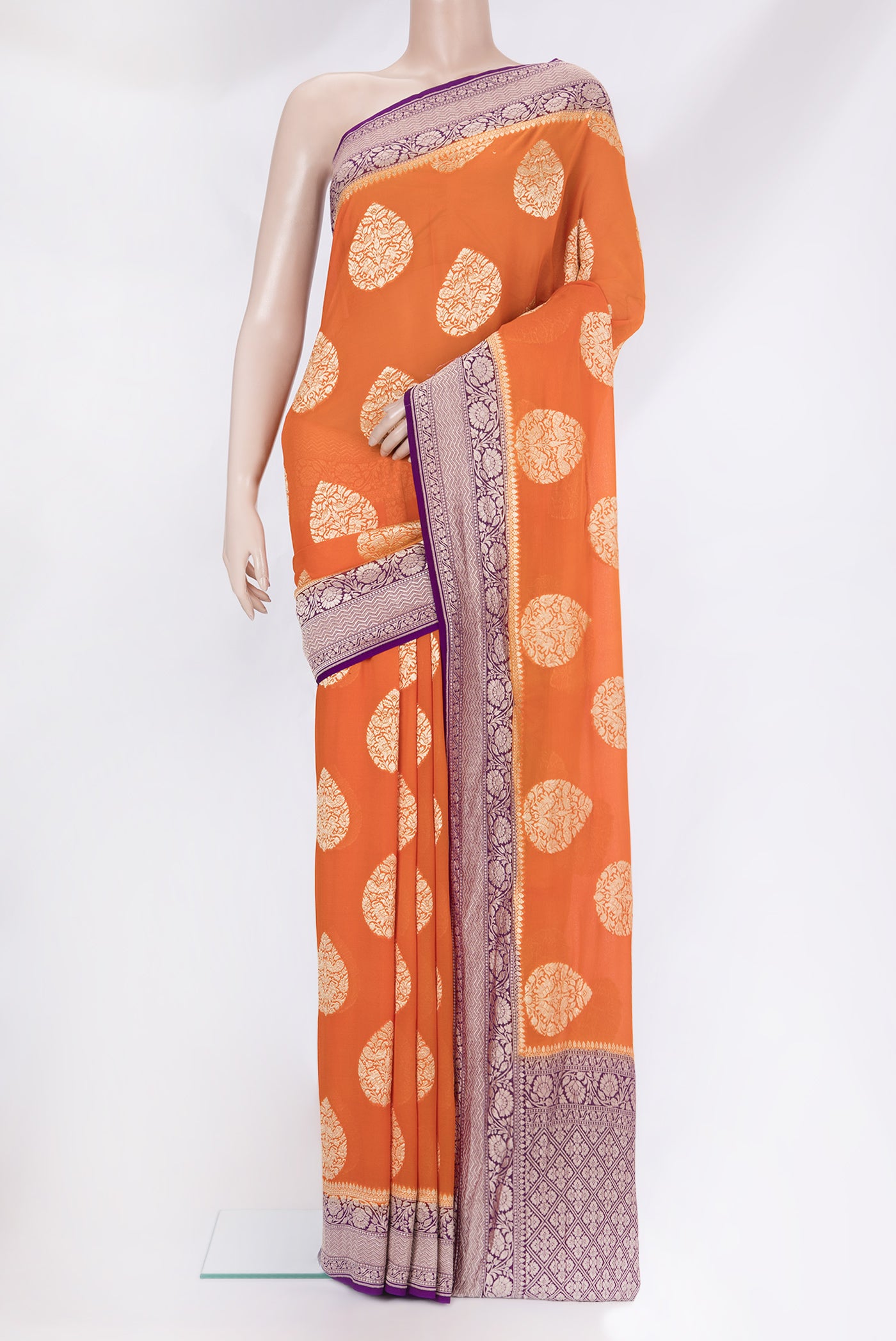 Orange Banarasi Georgette Saree with Zari Butta on the body and Zari Border.  displayed on a mannequin