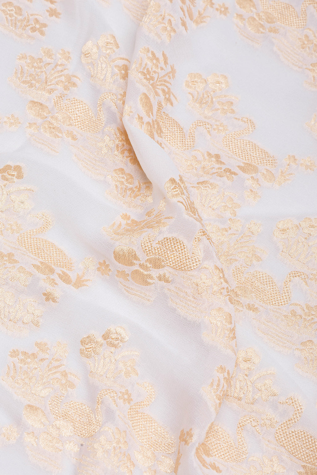 Close up of Off White Banarasi Georgette Saree with Zari Brocade on the body and Zari Border.  displaying folds