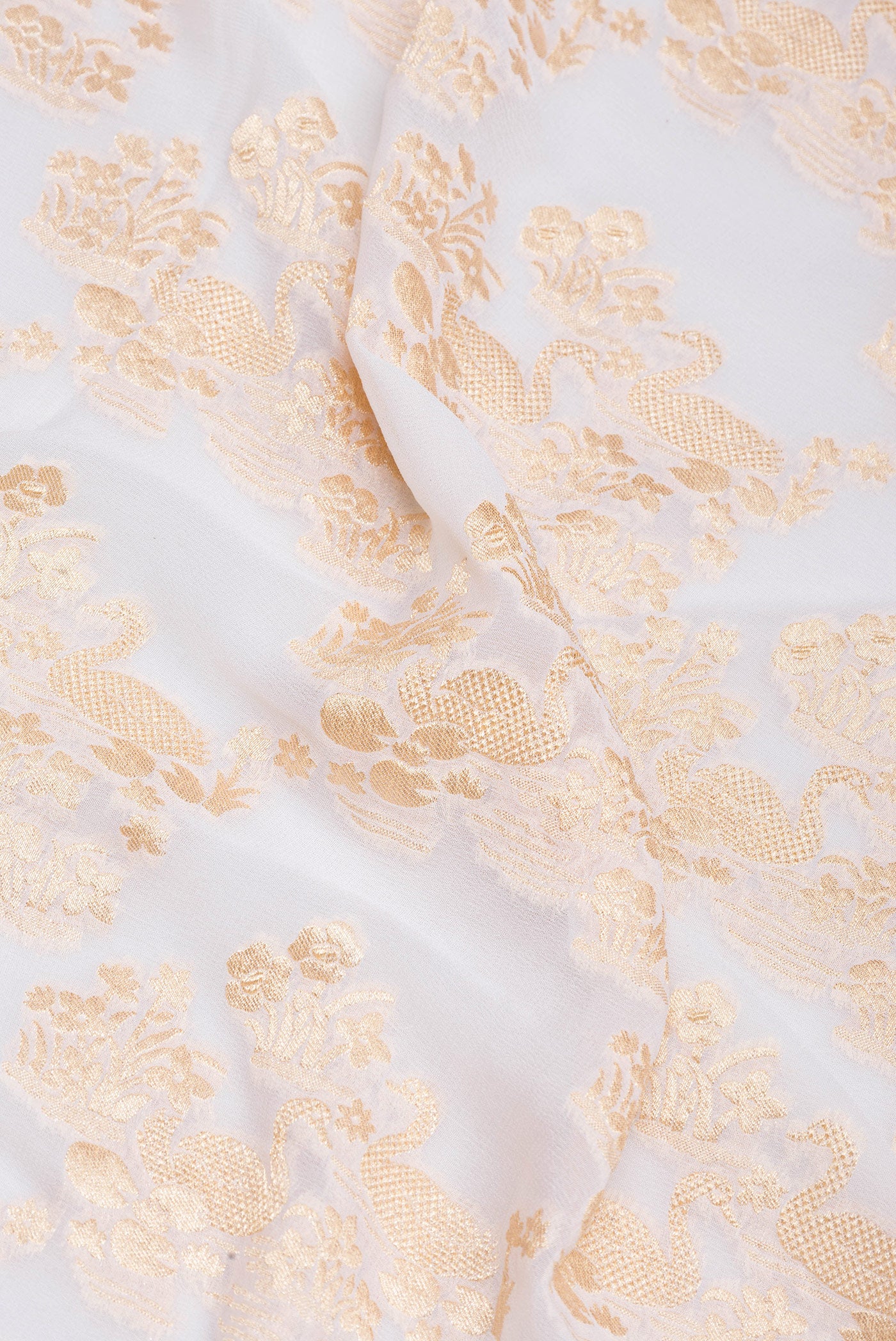 Close up of Off White Banarasi Georgette Saree with Zari Brocade on the body and Zari Border.  displaying folds