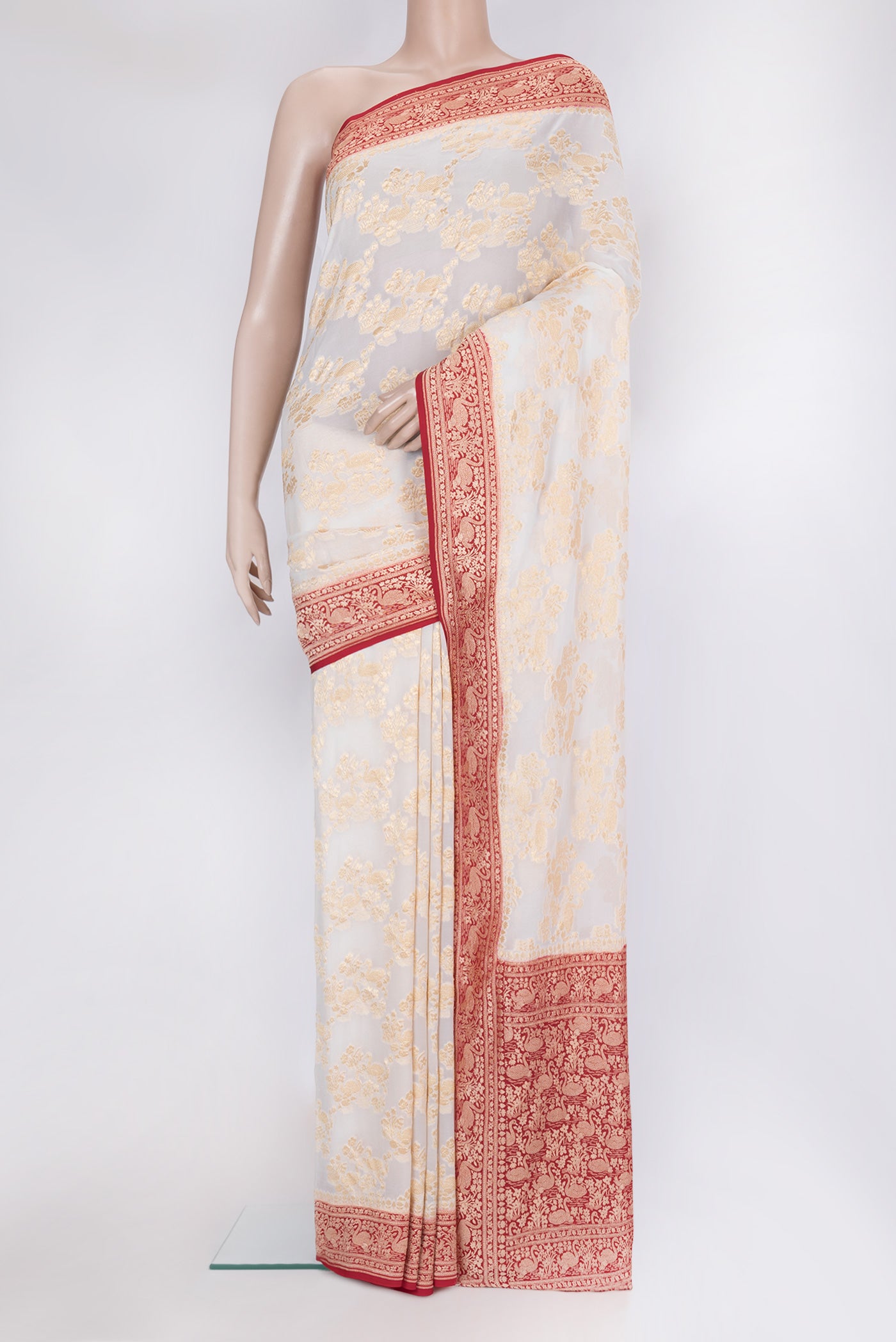 Off White Banarasi Georgette Saree with Zari Brocade on the body and Zari Border.  displayed on a mannequin