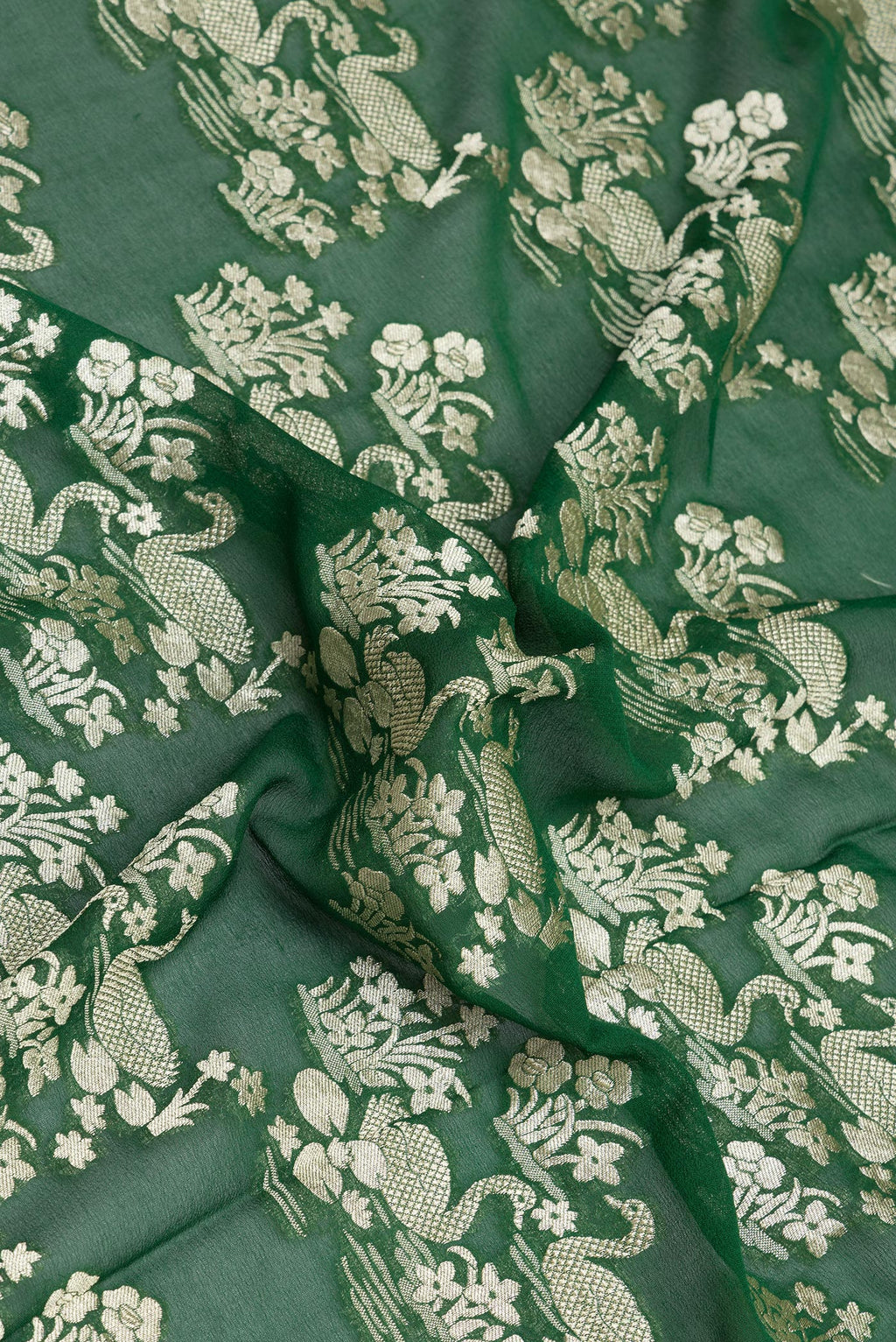 Close up of Bottle Green Banarasi Georgette Saree with Zari Brocade on the body and Zari Border.  displaying folds