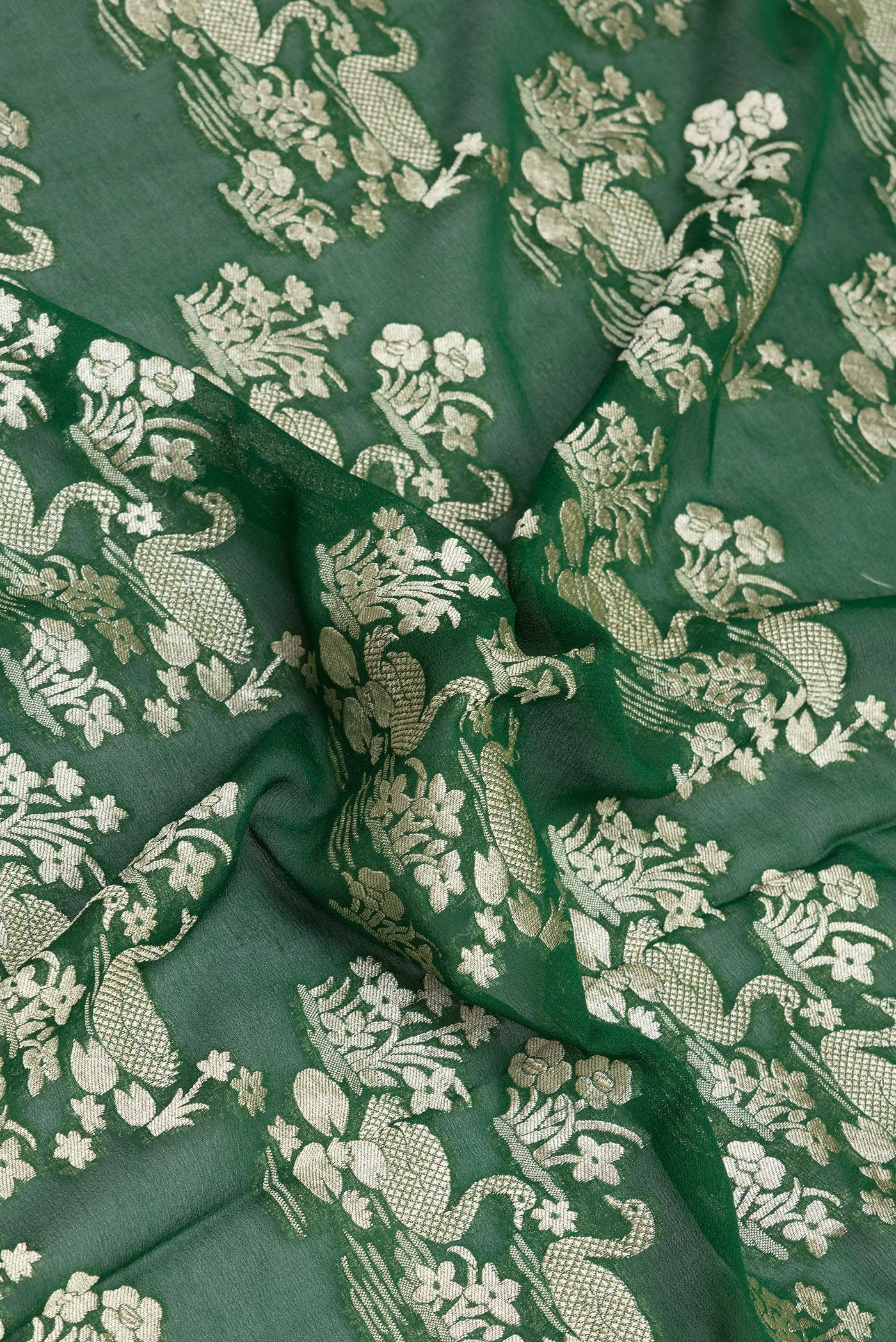 Close up of Bottle Green Banarasi Georgette Saree with Zari Brocade on the body and Zari Border.  displaying folds