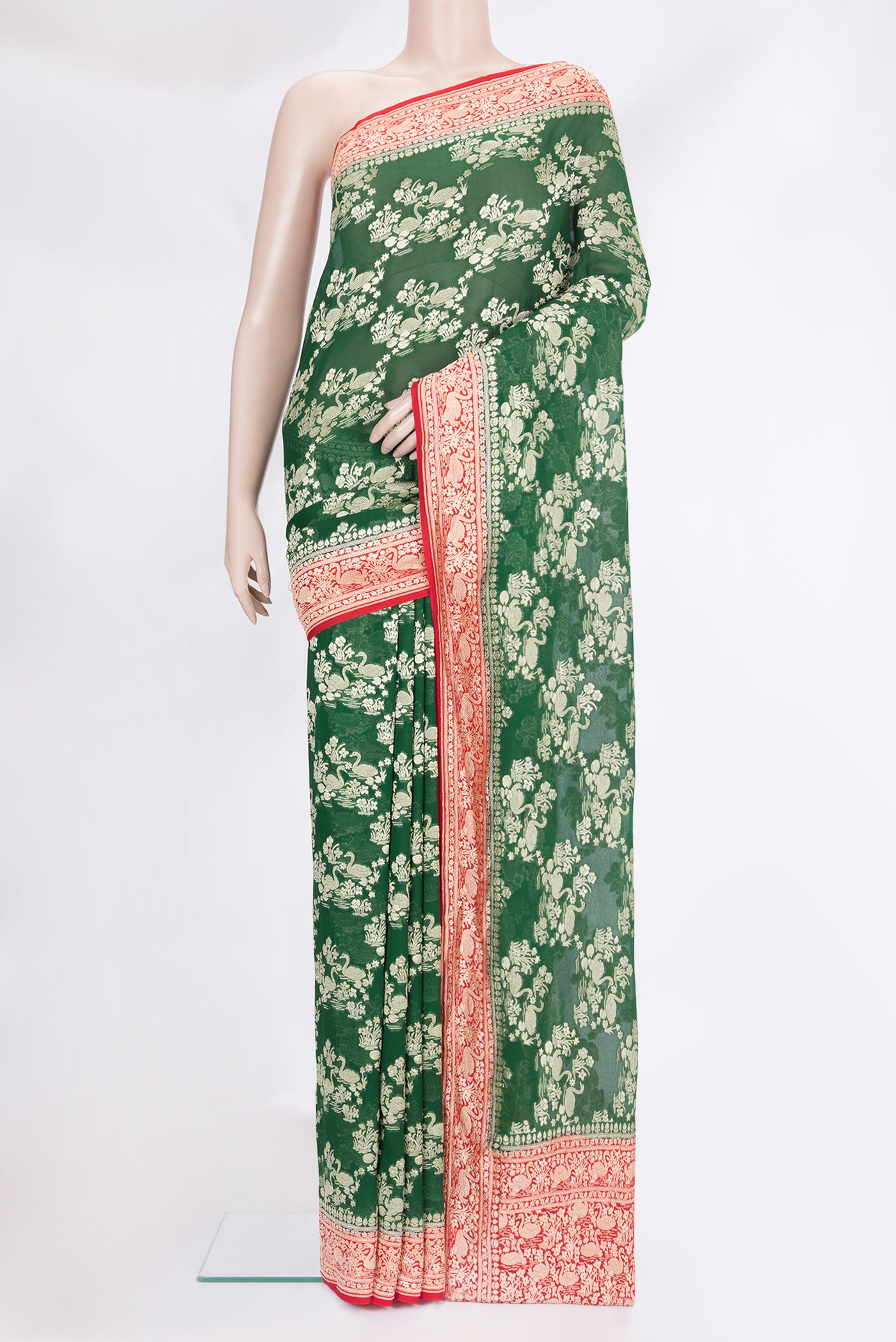 Bottle Green Banarasi Georgette Saree with Zari Brocade on the body and Zari Border.  displayed on a mannequin