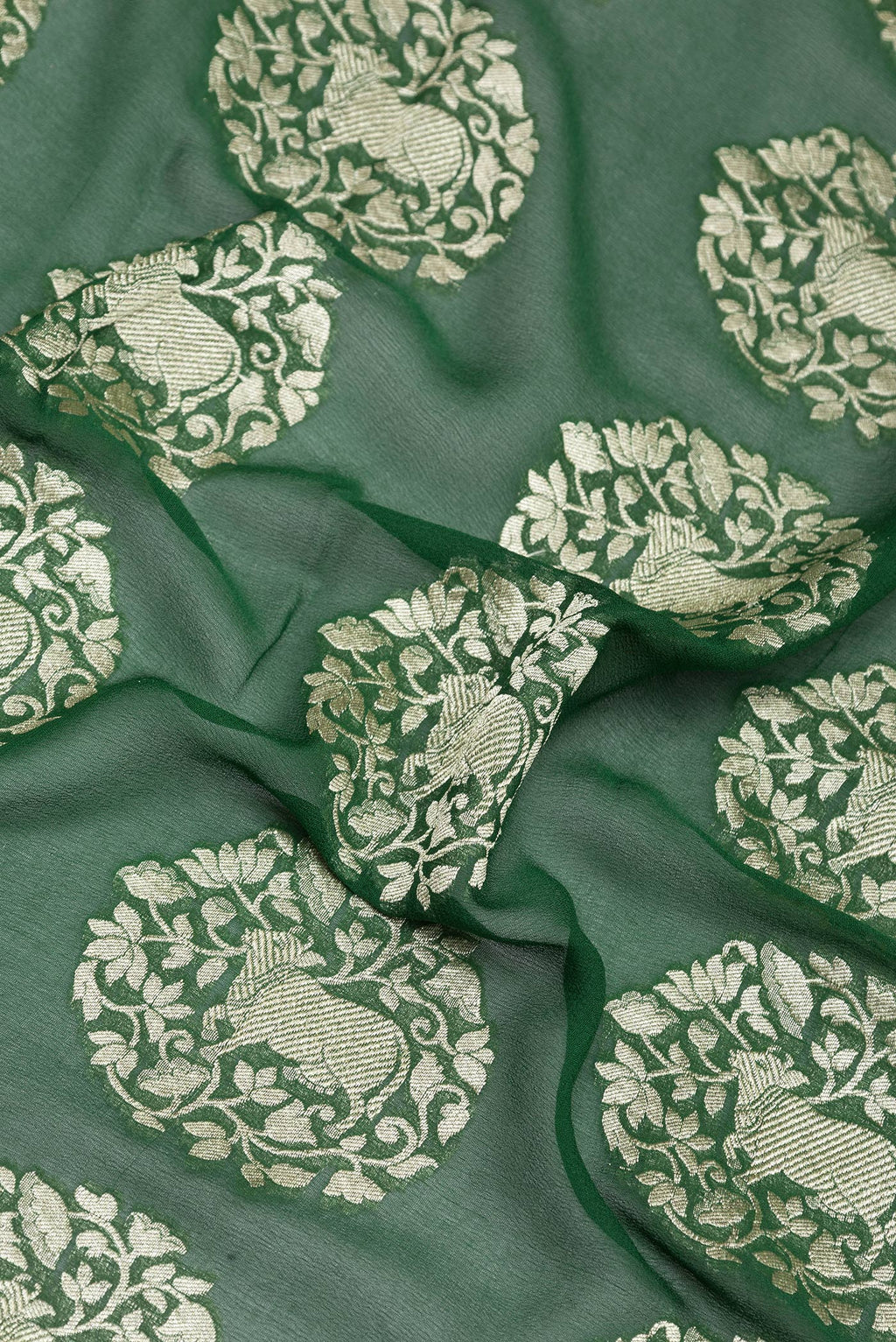Close up of Bottle Green Banarasi Georgette Saree with Zari Brocade on the body and Zari Border.  displaying folds