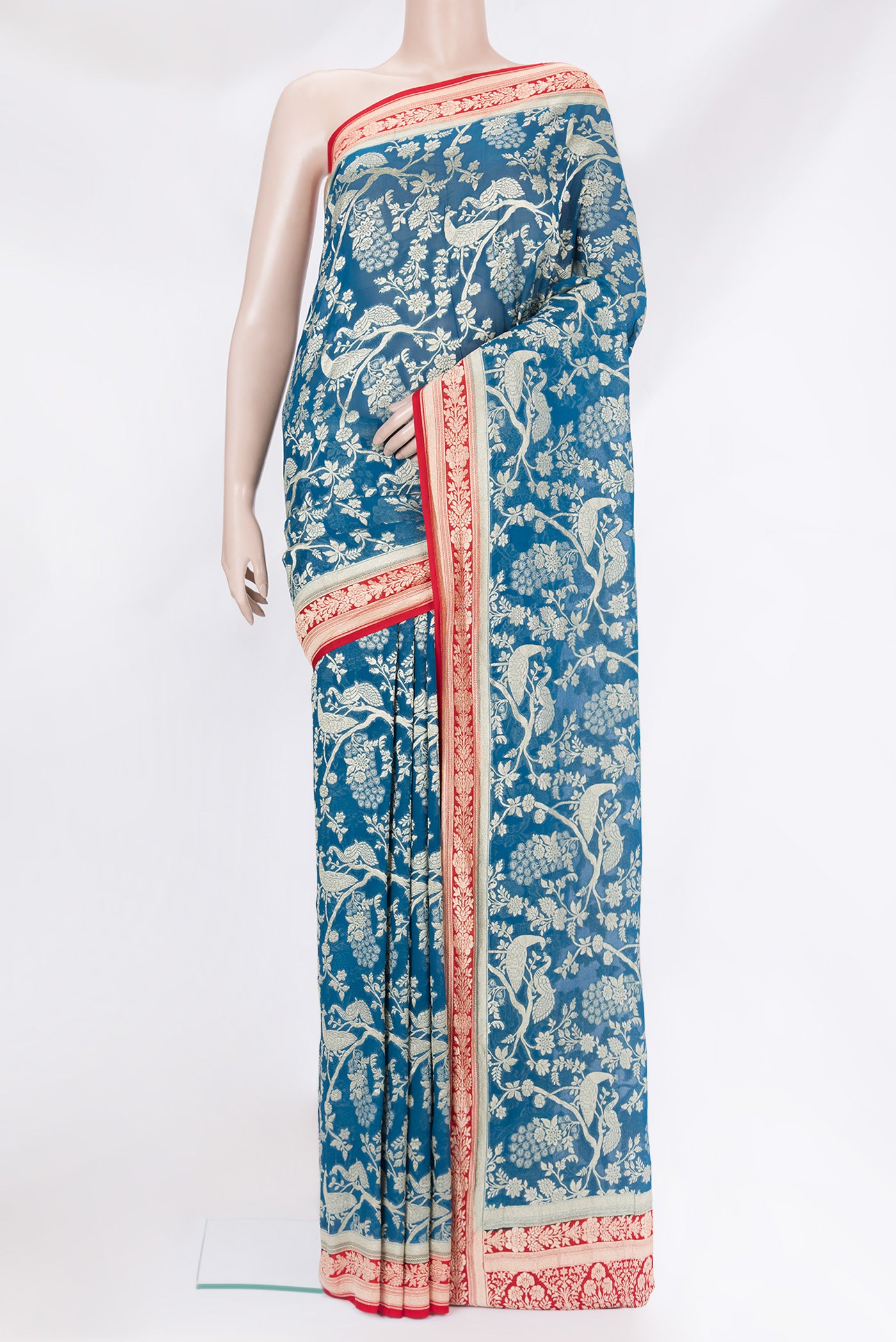 Peacock Blue Banarasi Georgette Saree with Zari Brocade on the body and Zari Border.  displayed on a mannequin