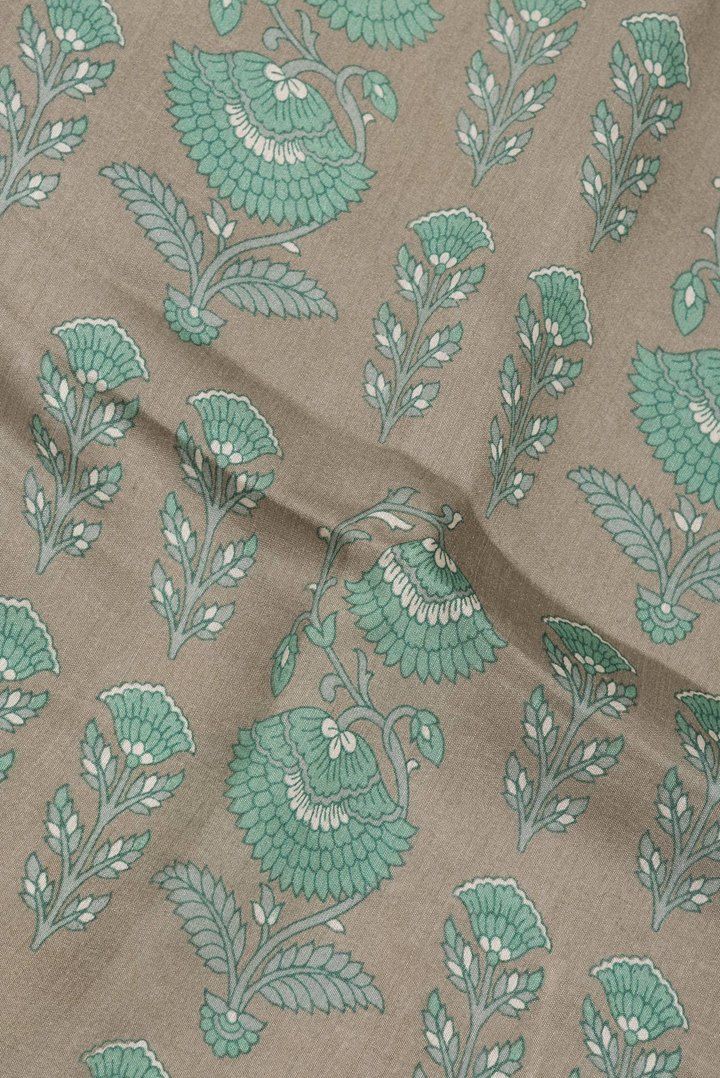 Close up of Green Tussar Silk Saree with Printed design on the body and Zari Border.  displaying folds