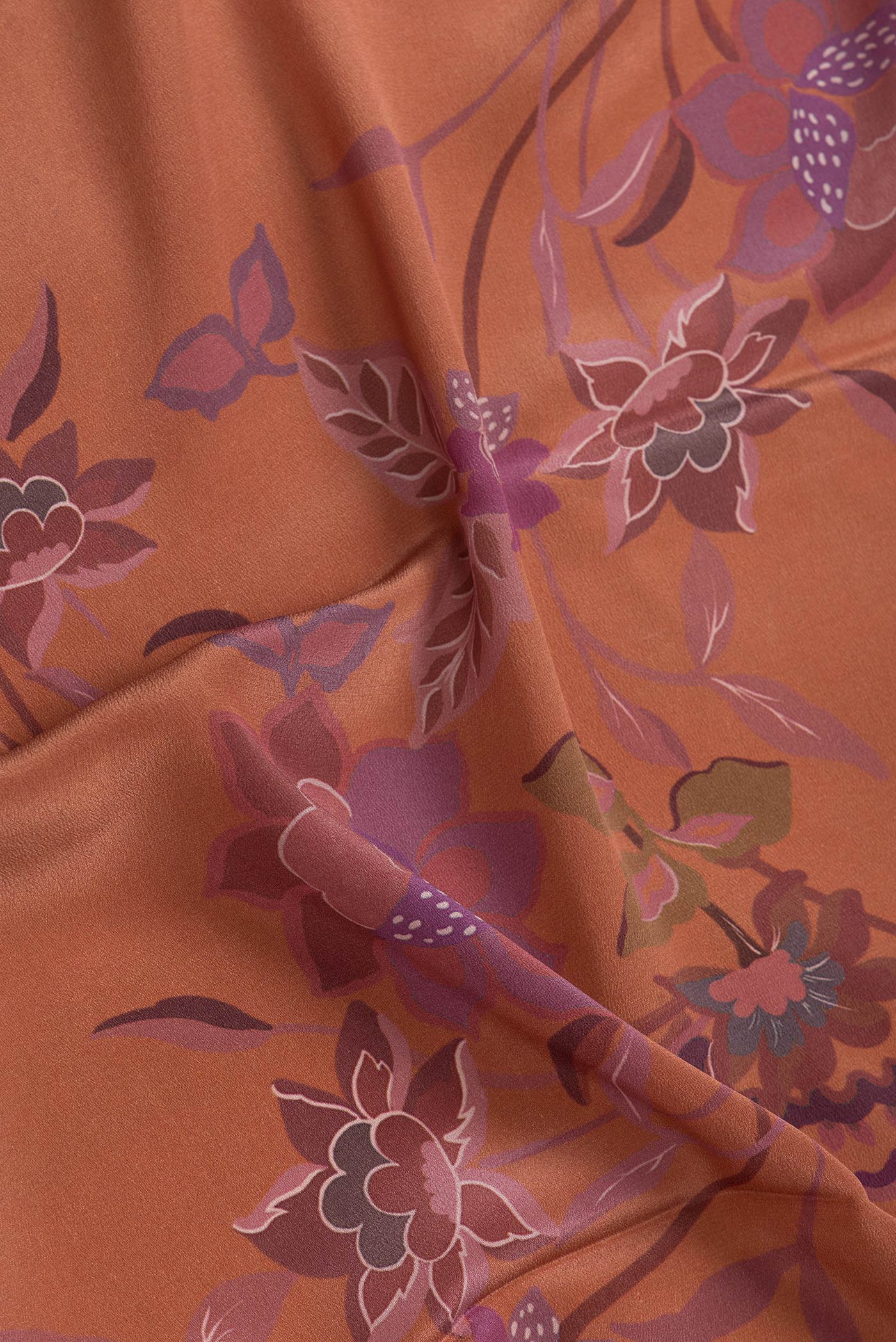 Close up of Brown Dual Tone Mysore Crepe Saree with Printed design on the body and Without Border.  displaying folds