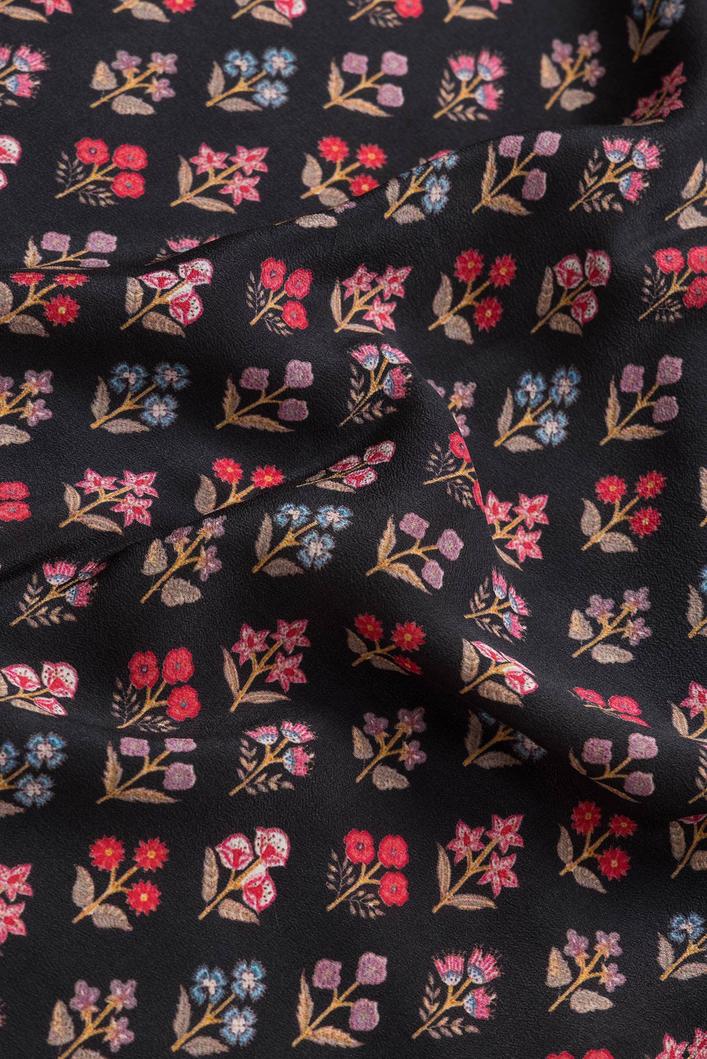 Close up of Black Dual Tone Mysore Crepe Saree with Printed design on the body and Printed Border.  displaying folds