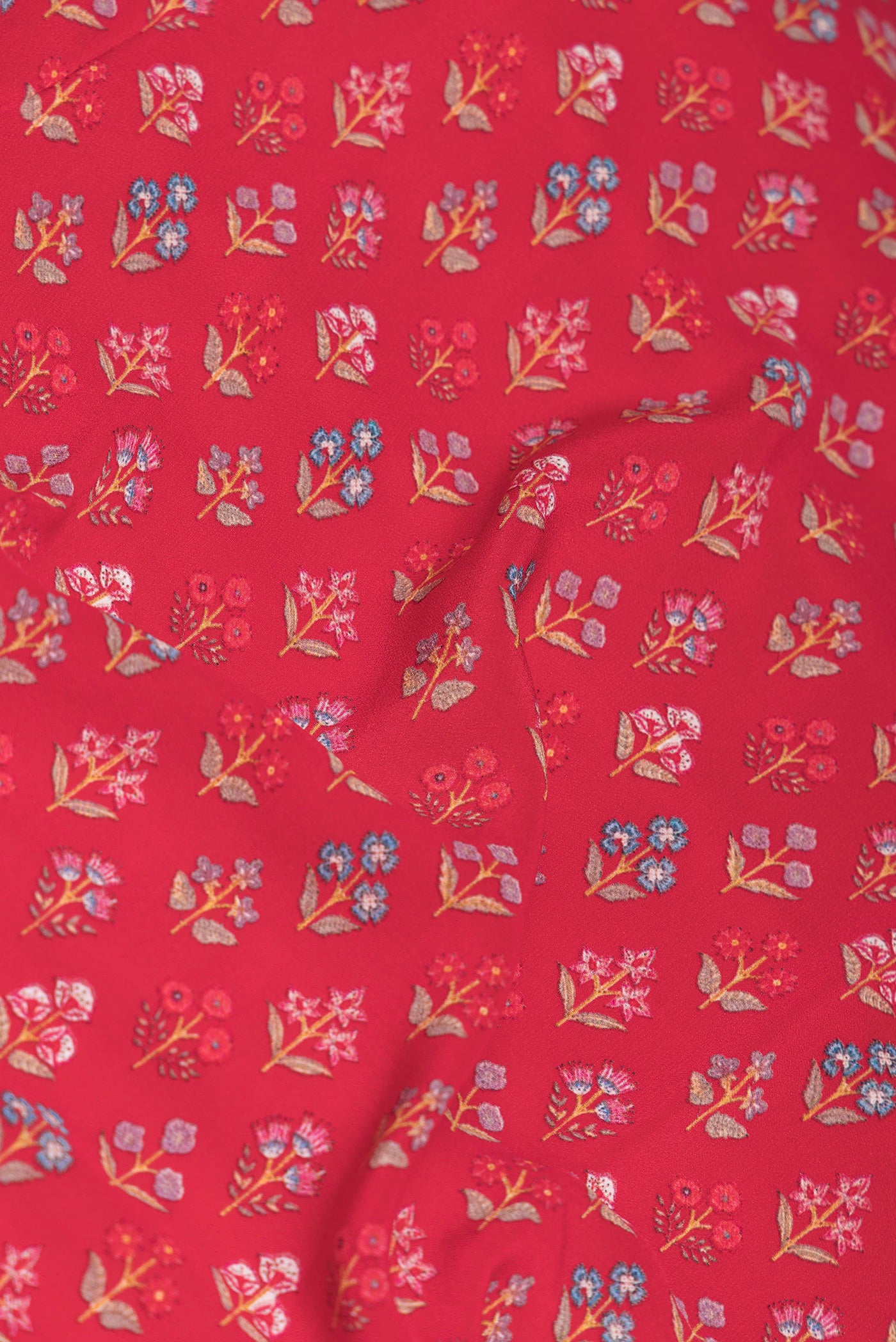 Close up of Red Dual Tone Mysore Crepe Saree with Printed design on the body and Printed Border.  displaying folds