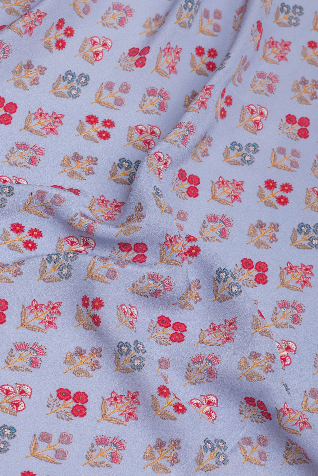 Close up of Grey Crepe Saree with Printed design on the body and Printed Border.  displaying folds