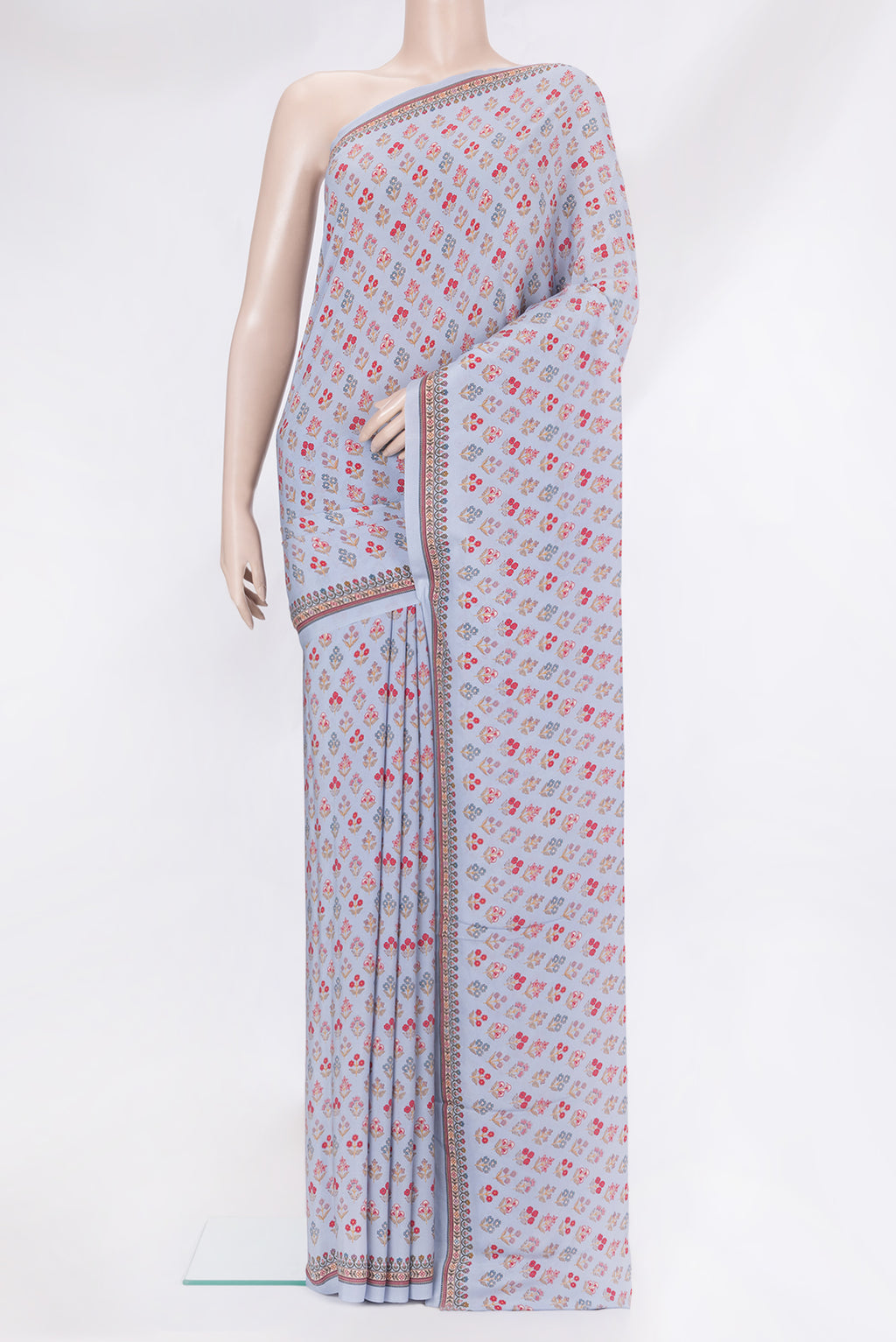 Grey Crepe Saree with Printed design on the body and Printed Border.  displayed on a mannequin