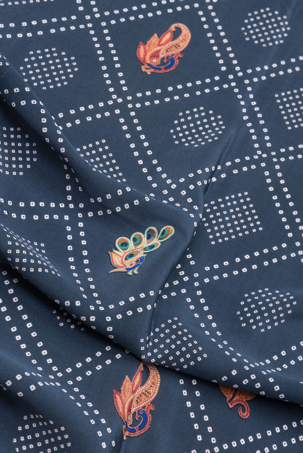 Close up of Blue Grey Dual Tone Mysore Crepe Saree with Printed design on the body and Zari Border.  displaying folds