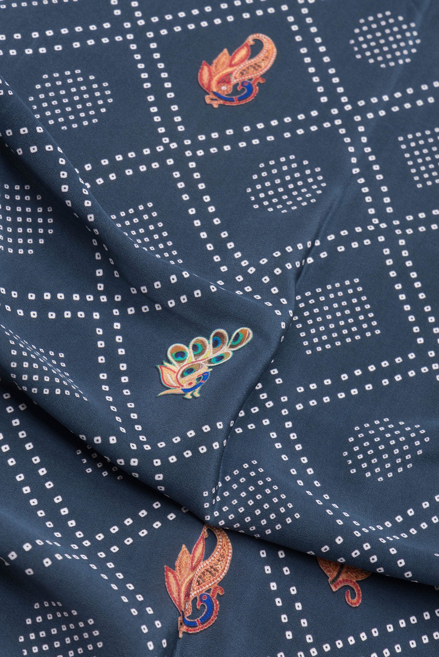 Close up of Blue Grey Dual Tone Mysore Crepe Saree with Printed design on the body and Zari Border.  displaying folds