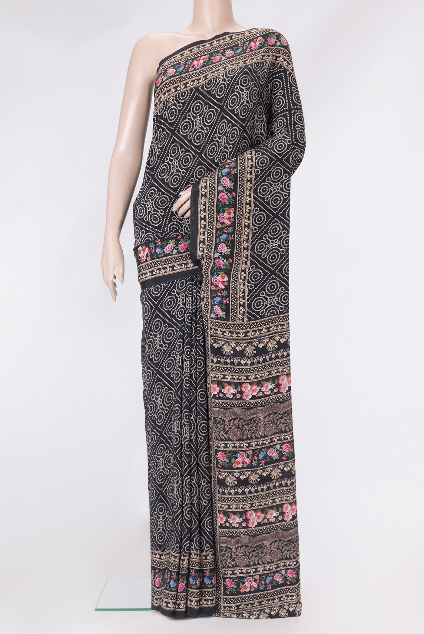 Black Crepe Saree with Bandhani Print on the body and Printed Border.  displayed on a mannequin