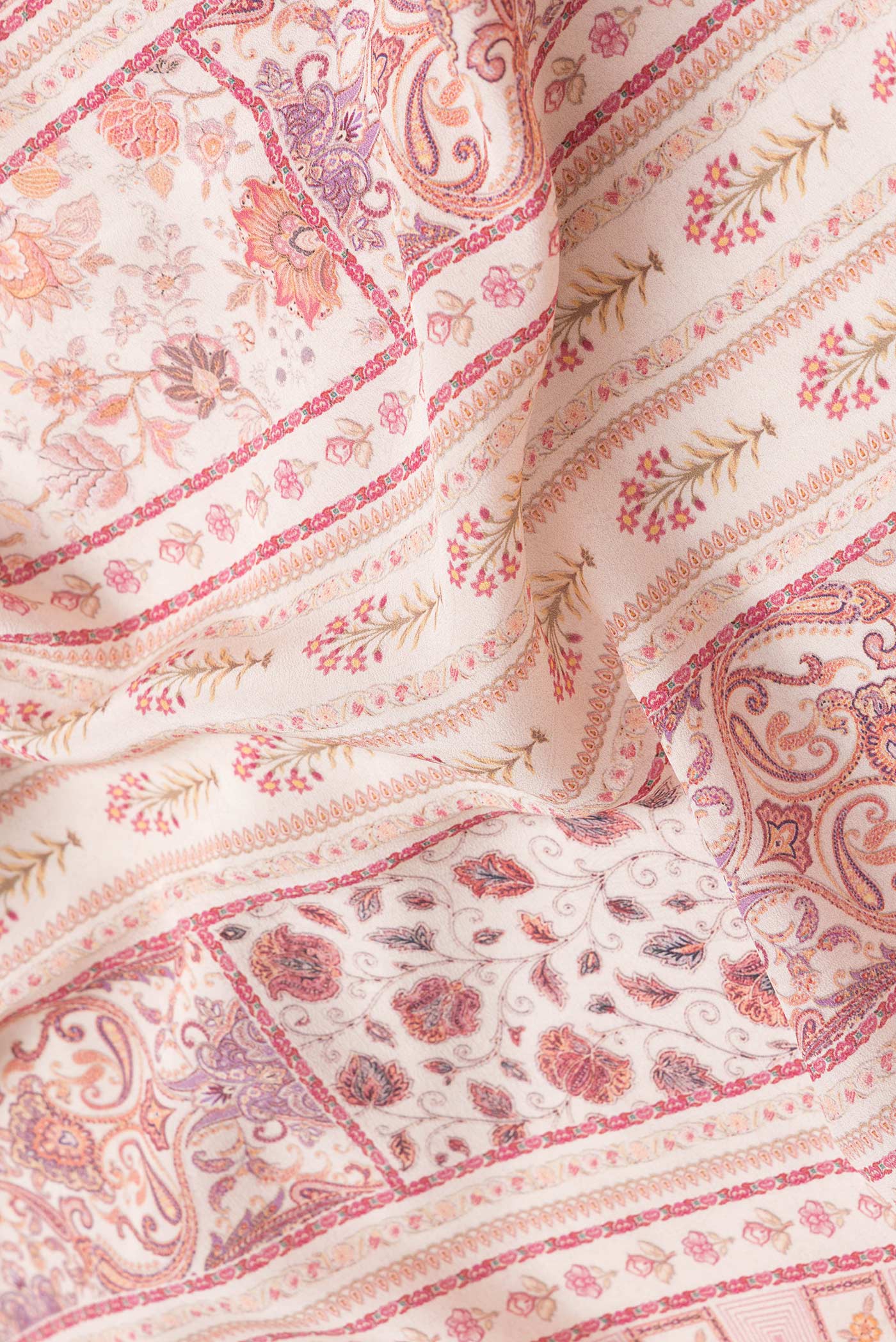 Close up of Beige Dual Tone Mysore Crepe Saree with Printed design on the body and Printed Border.  displaying folds