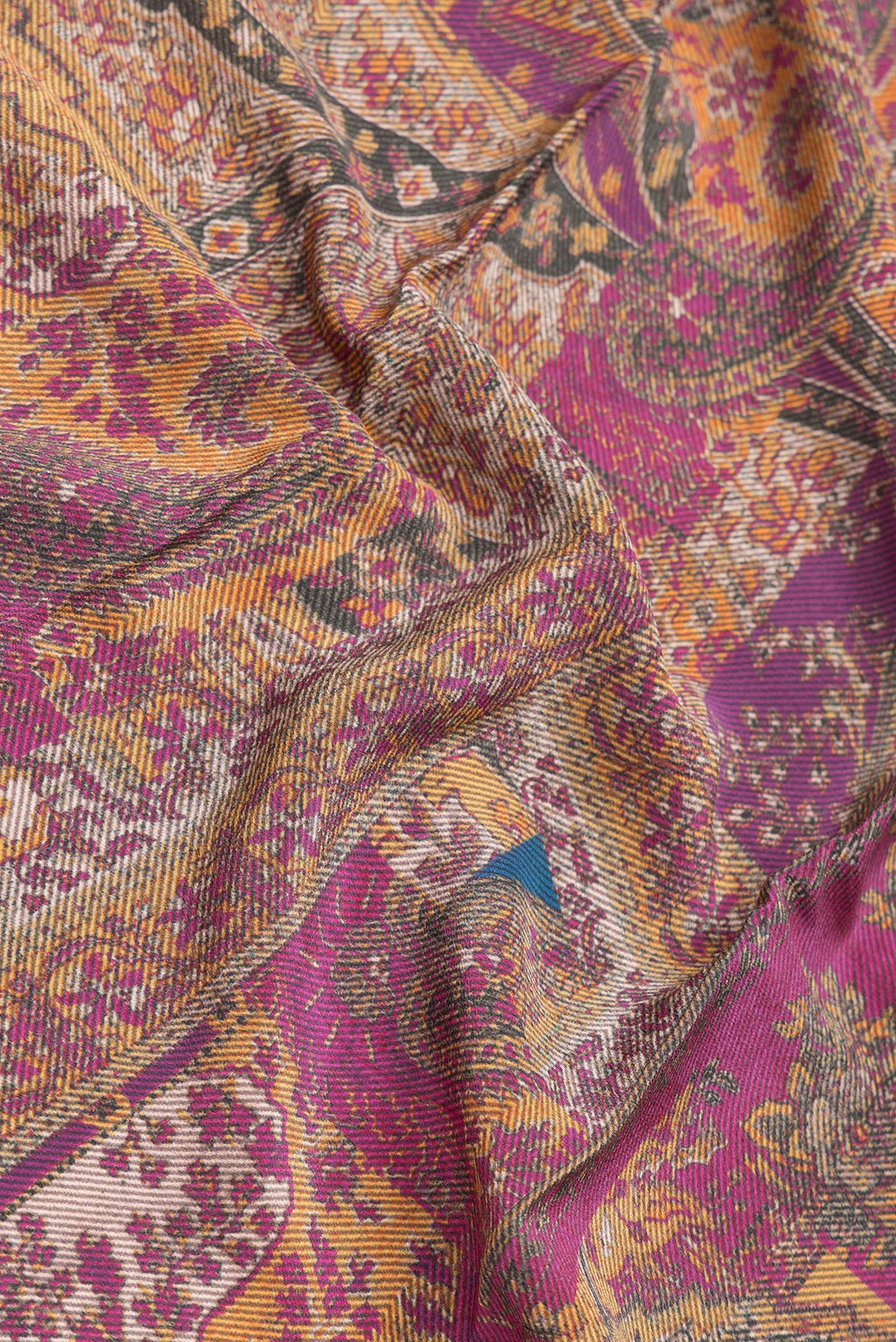 Close up of Magenta Dual Tone Mysore Crepe Saree with Printed design on the body and Printed Border.  displaying folds