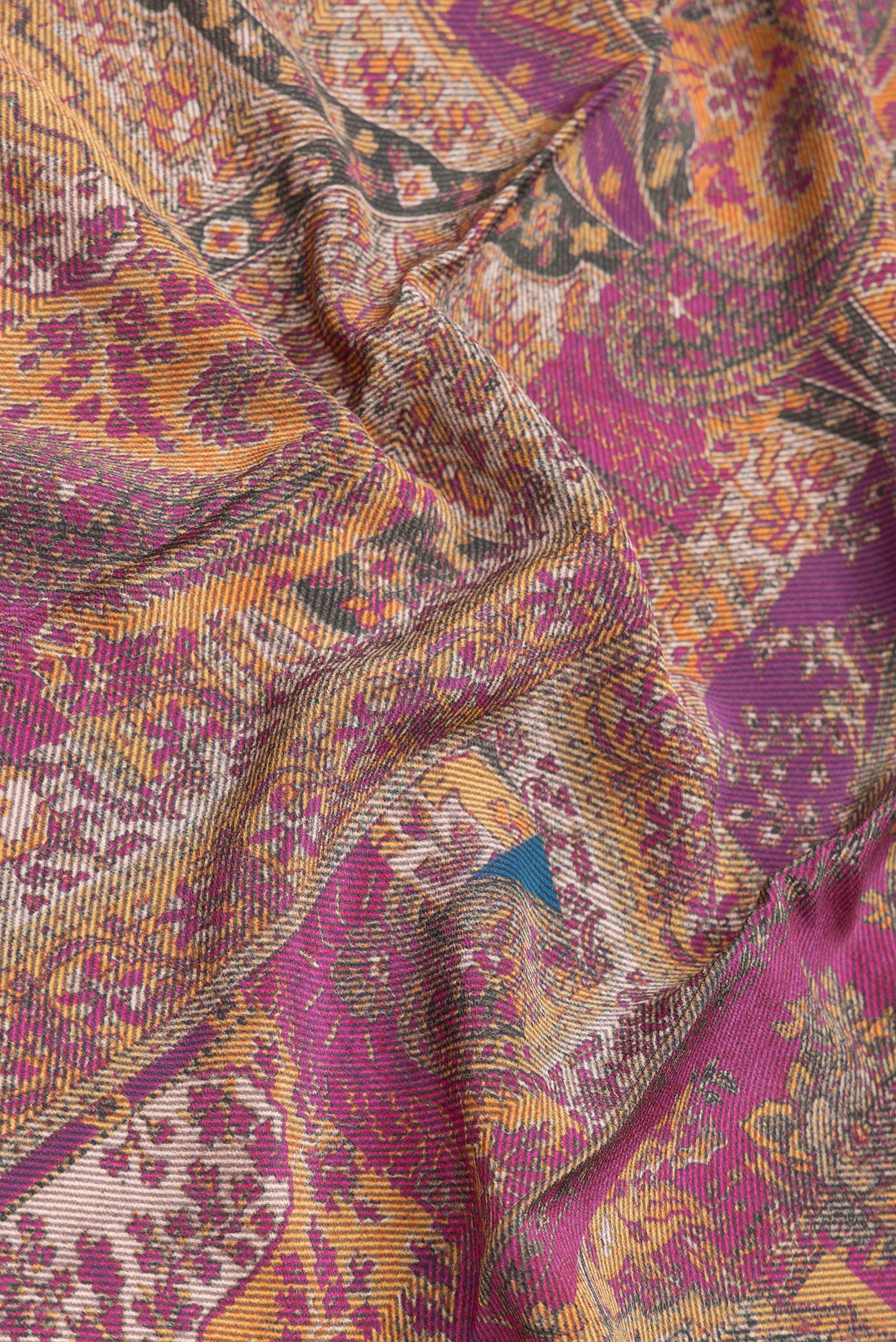 Close up of Magenta Dual Tone Mysore Crepe Saree with Printed design on the body and Printed Border.  displaying folds