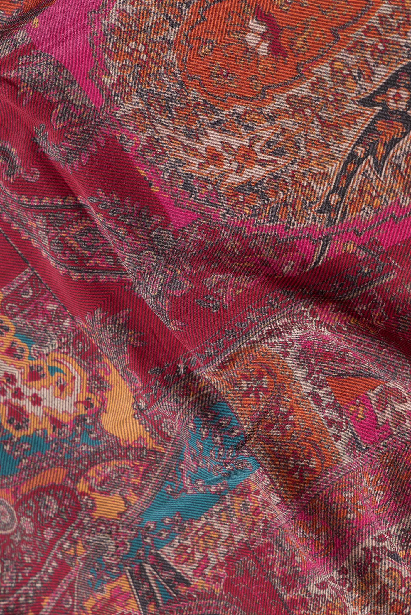 Close up of Maroon Dual Tone Mysore Crepe Saree with Printed design on the body and Printed Border.  displaying folds