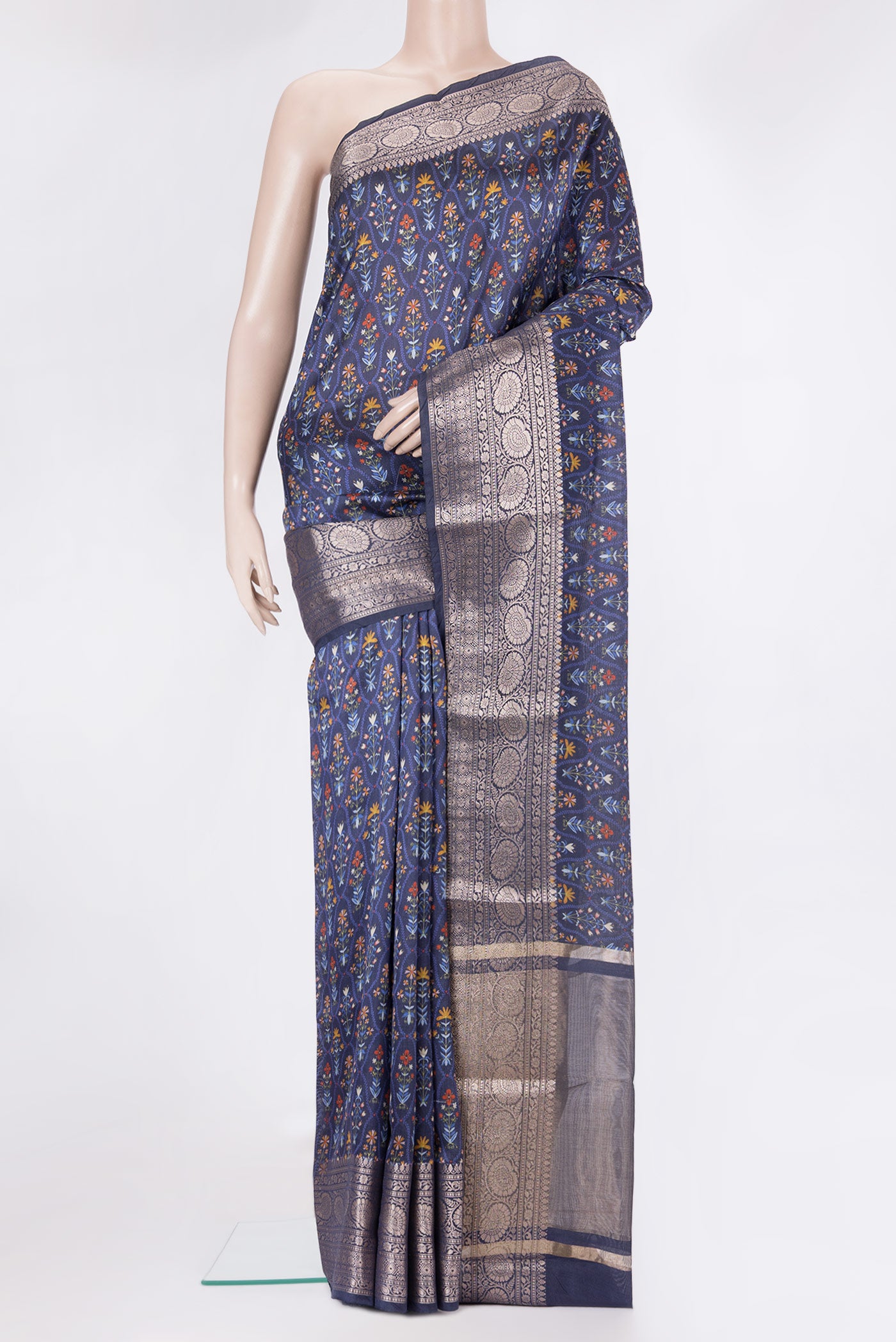 Navy Blue Tussar Silk Saree with Printed design on the body and Zari Border.  displayed on a mannequin