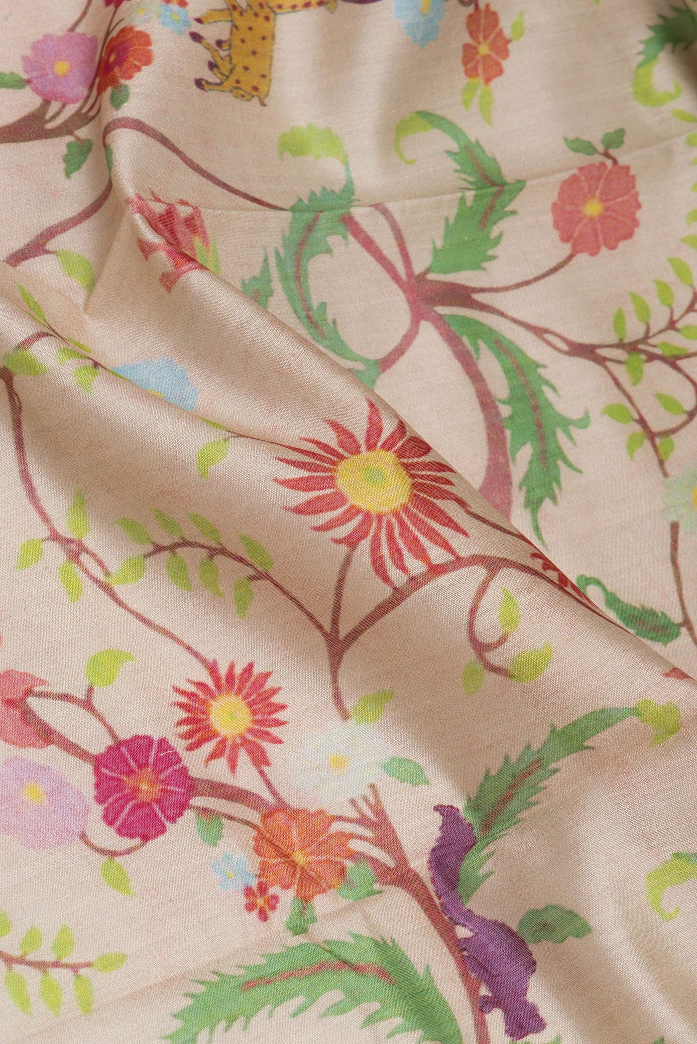 Close up of Beige Chanderi Silk Saree with Printed design on the body and Fancy Border.  displaying folds
