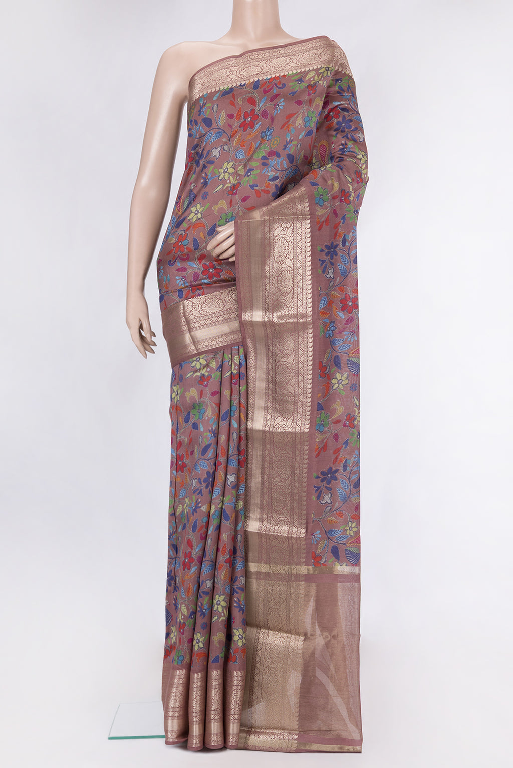 Brown Tussar Silk Saree with Printed design on the body and Zari Border.  displayed on a mannequin