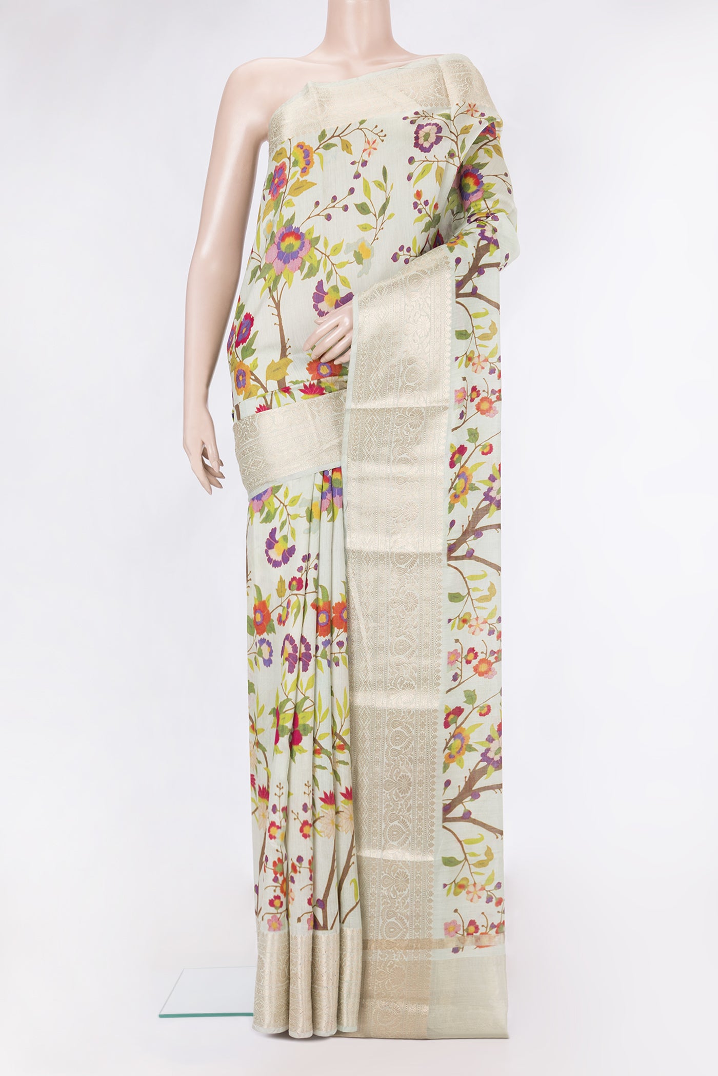 Pista Green Tussar Silk Saree with Printed design on the body and Zari Border.  displayed on a mannequin