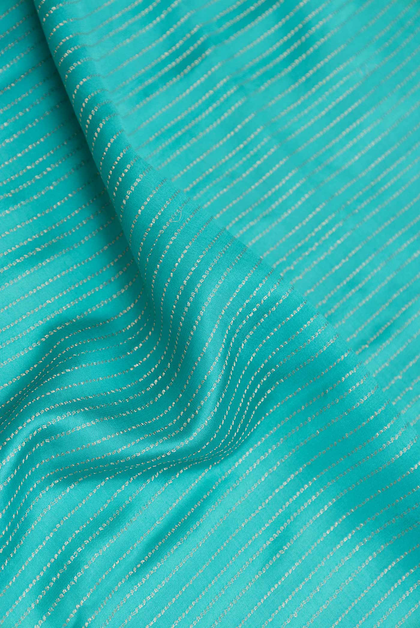 Close up of Sky Blue Mysore Crepe Saree with Stripes on the body and Zari Border displaying folds